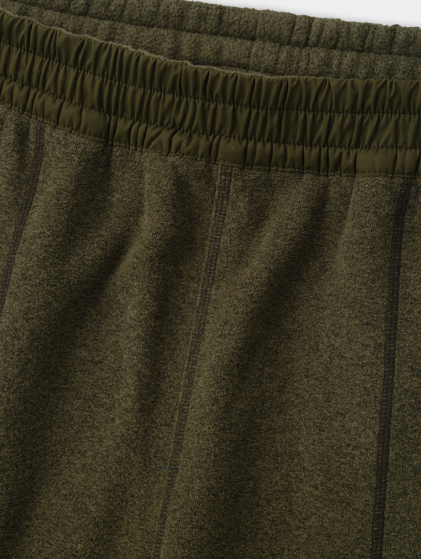 Closeup detailed view of the contrasting fabric encased waistband on the Sutherlin Pant in Forest Green from AETHER Apparel.