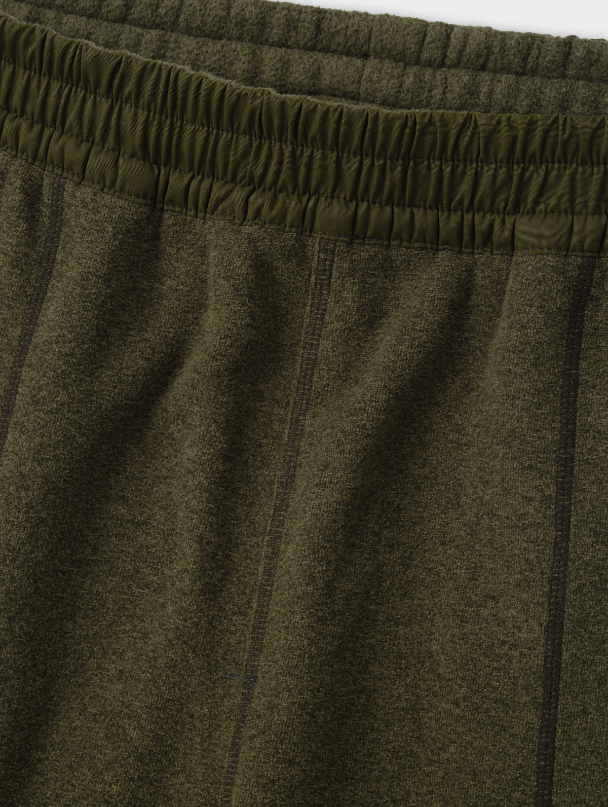 Closeup detailed view of the contrasting fabric encased waistband on the Sutherlin Pant in Forest Green from AETHER Apparel.