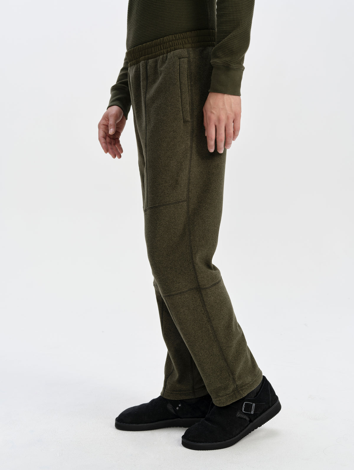 Side profile lower-body view of man wearing the Sutherlin Pant in Forest Green from AETHER Apparel.