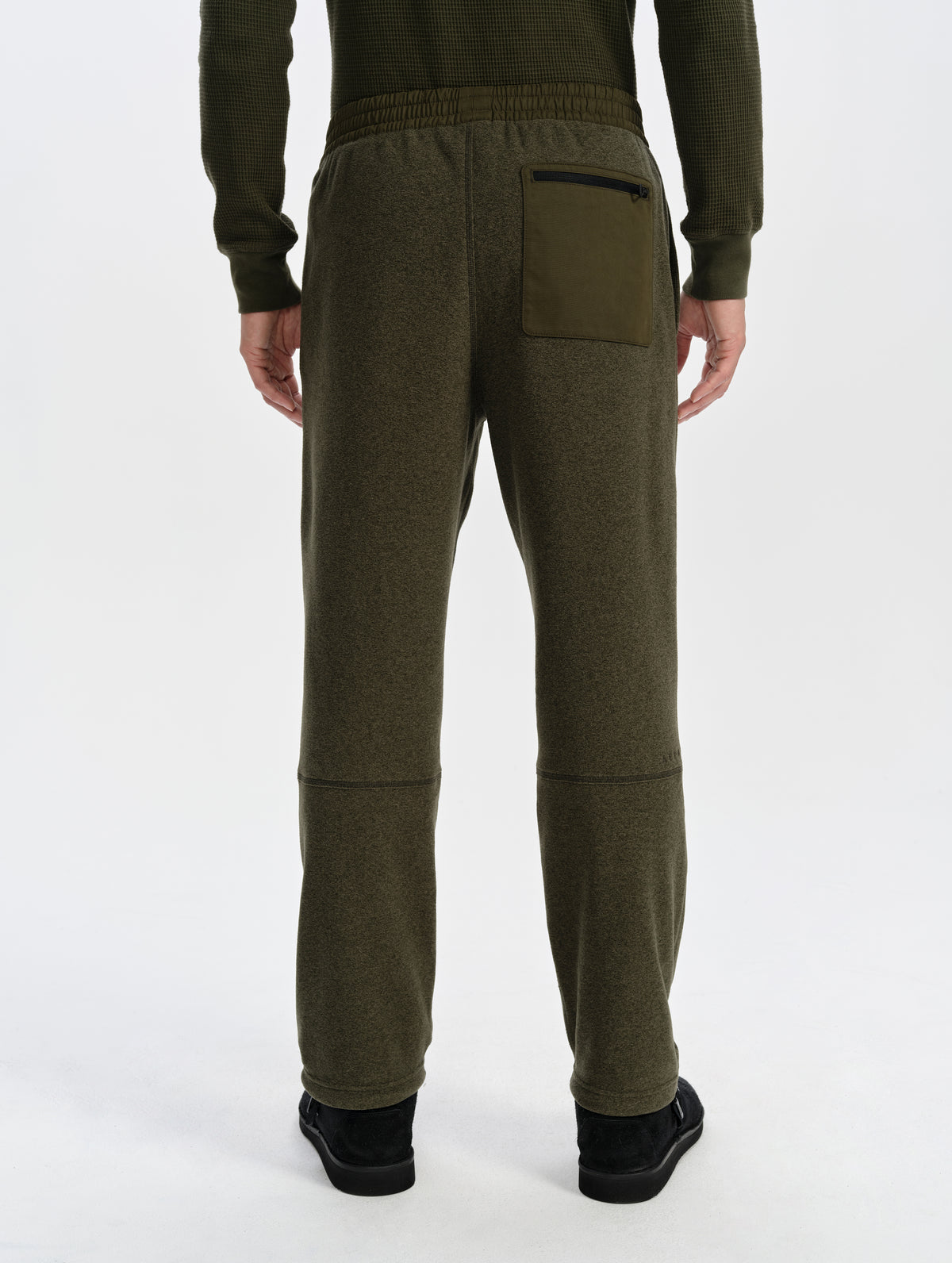 Rear lower-body view of man wearing the Sutherlin Pant in Forest Green from AETHER Apparel.