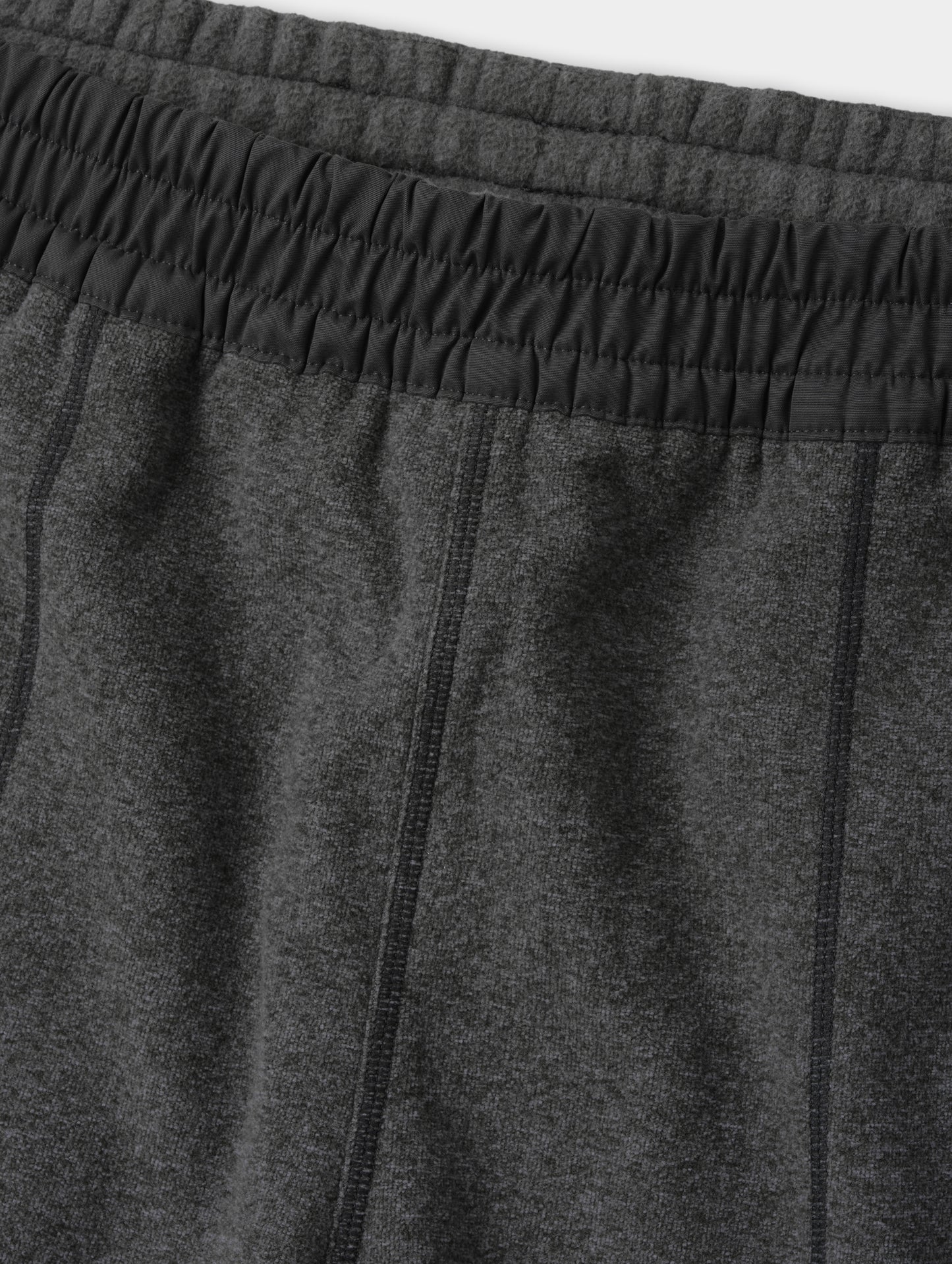 Closeup detailed view of the contrasting fabric encased waistband on the Sutherlin Pant in Charcoal Grey from AETHER Apparel.