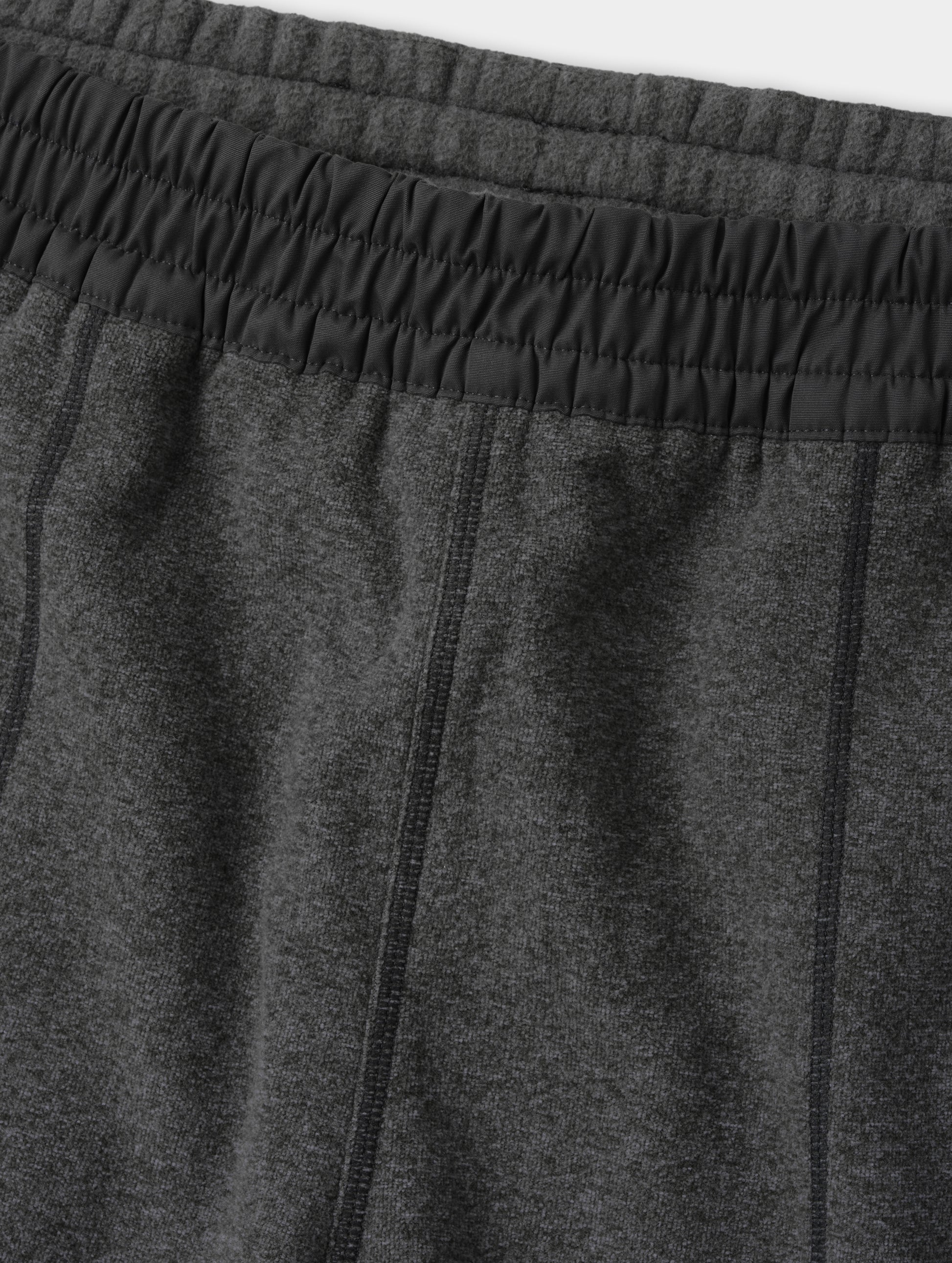 Closeup detailed view of the contrasting fabric encased waistband on the Sutherlin Pant in Charcoal Grey from AETHER Apparel.
