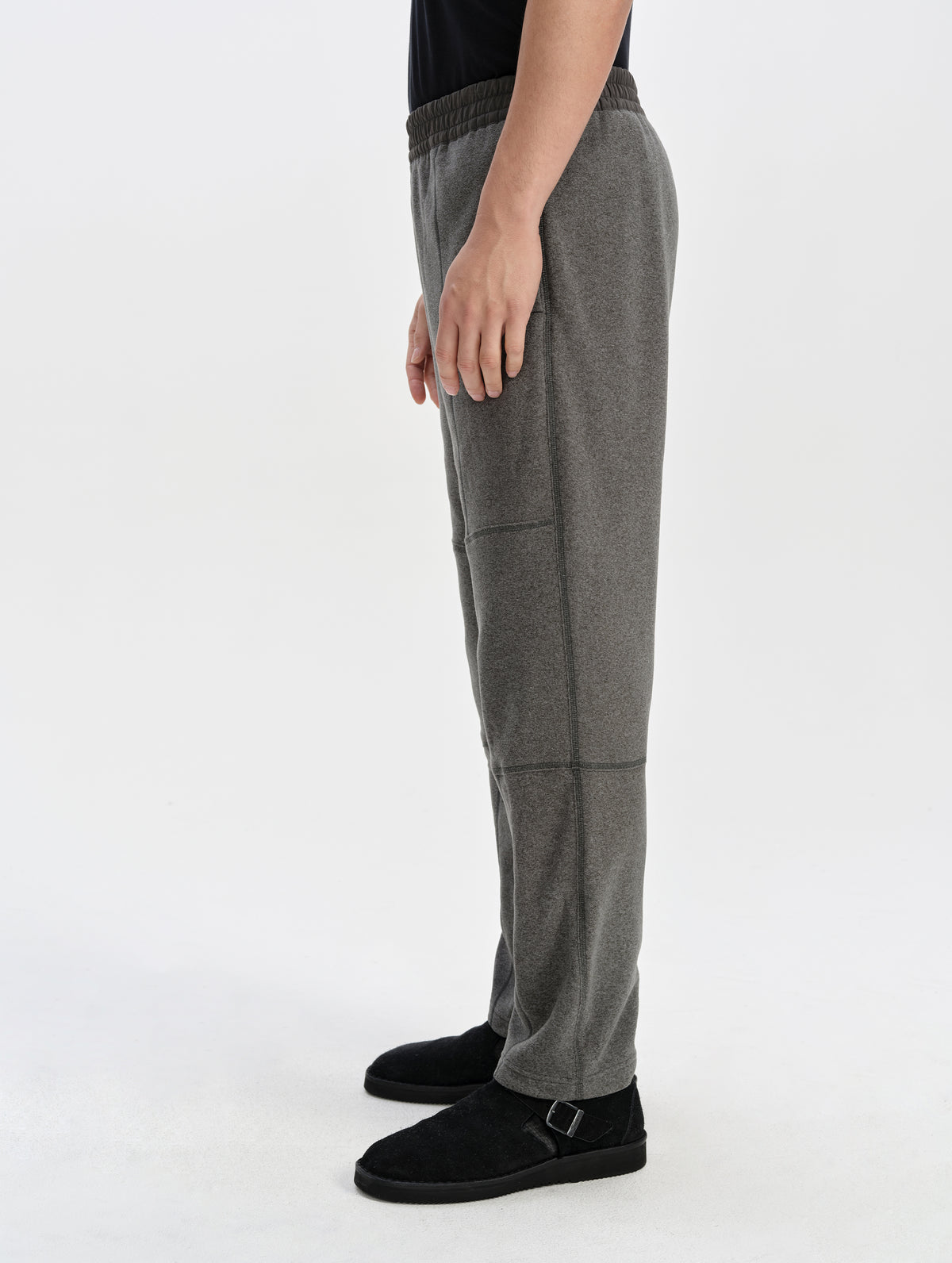 Side profile lower-body view of man wearing the Sutherlin Pant in Charcoal Grey from AETHER Apparel.