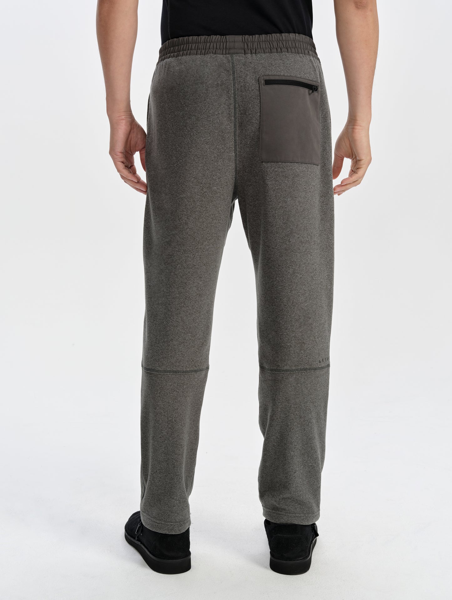 Rear lower-body view of man wearing the Sutherlin Pant in Charcoal Grey from AETHER Apparel.