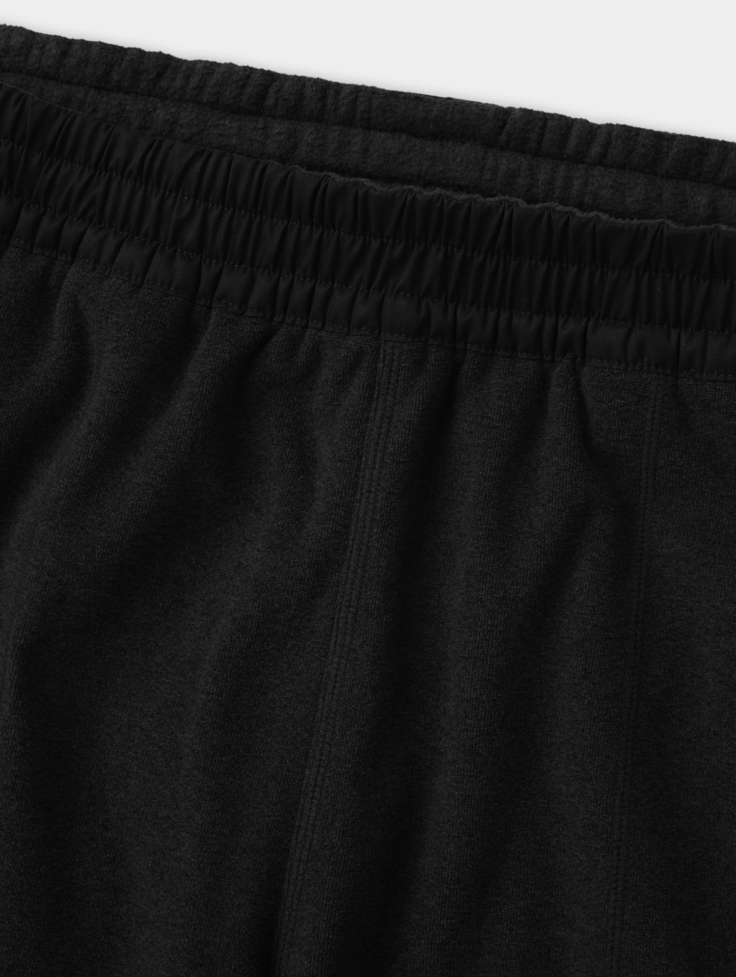 Closeup detailed view of the contrasting fabric encased waistband on the Sutherlin Pant in Onyx Black from AETHER Apparel.