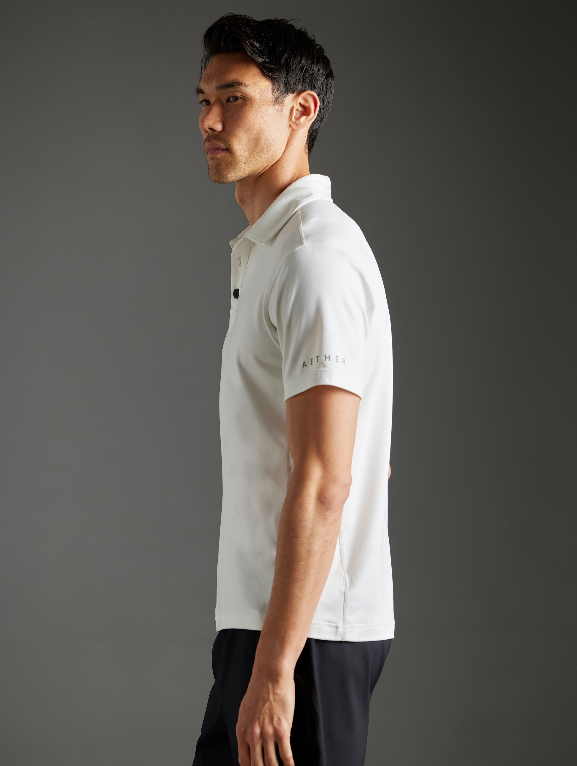 man wearing white polo from AETHER Apparel