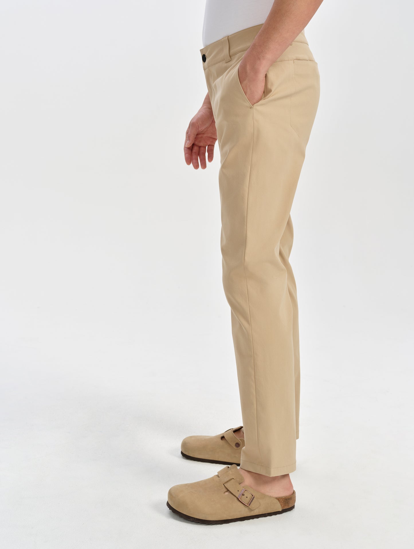 Side profile lower-body view of man wearing the Walden Tech Pant in Desert Tan from AETHER Apparel. 