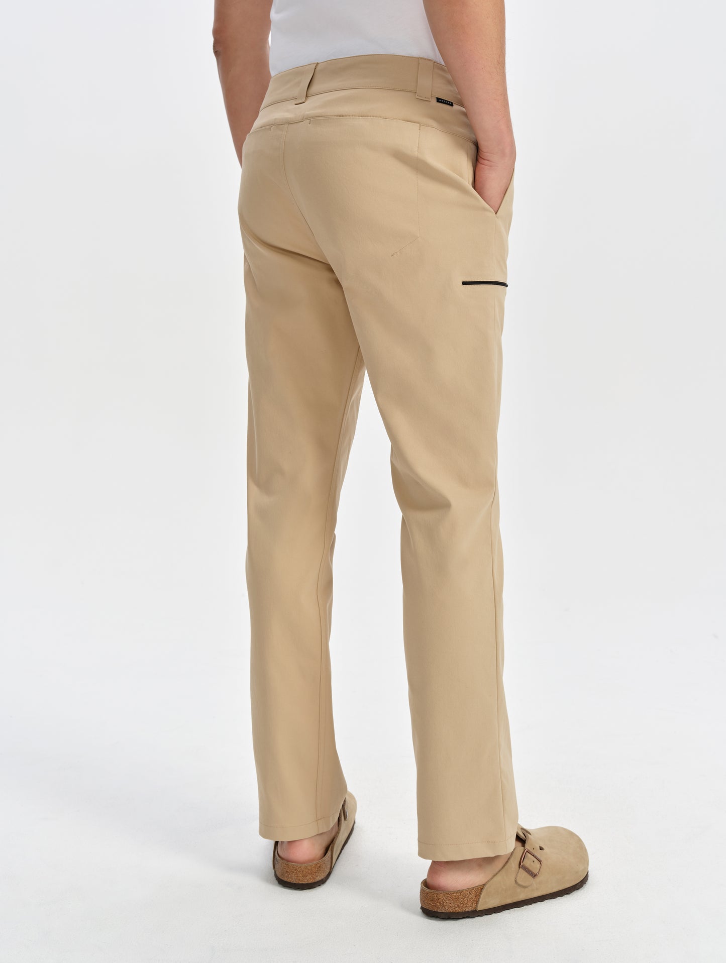 Rear 3/4 lower-body view of man wearing the Walden Tech Pant in Desert Tan from AETHER Apparel. 