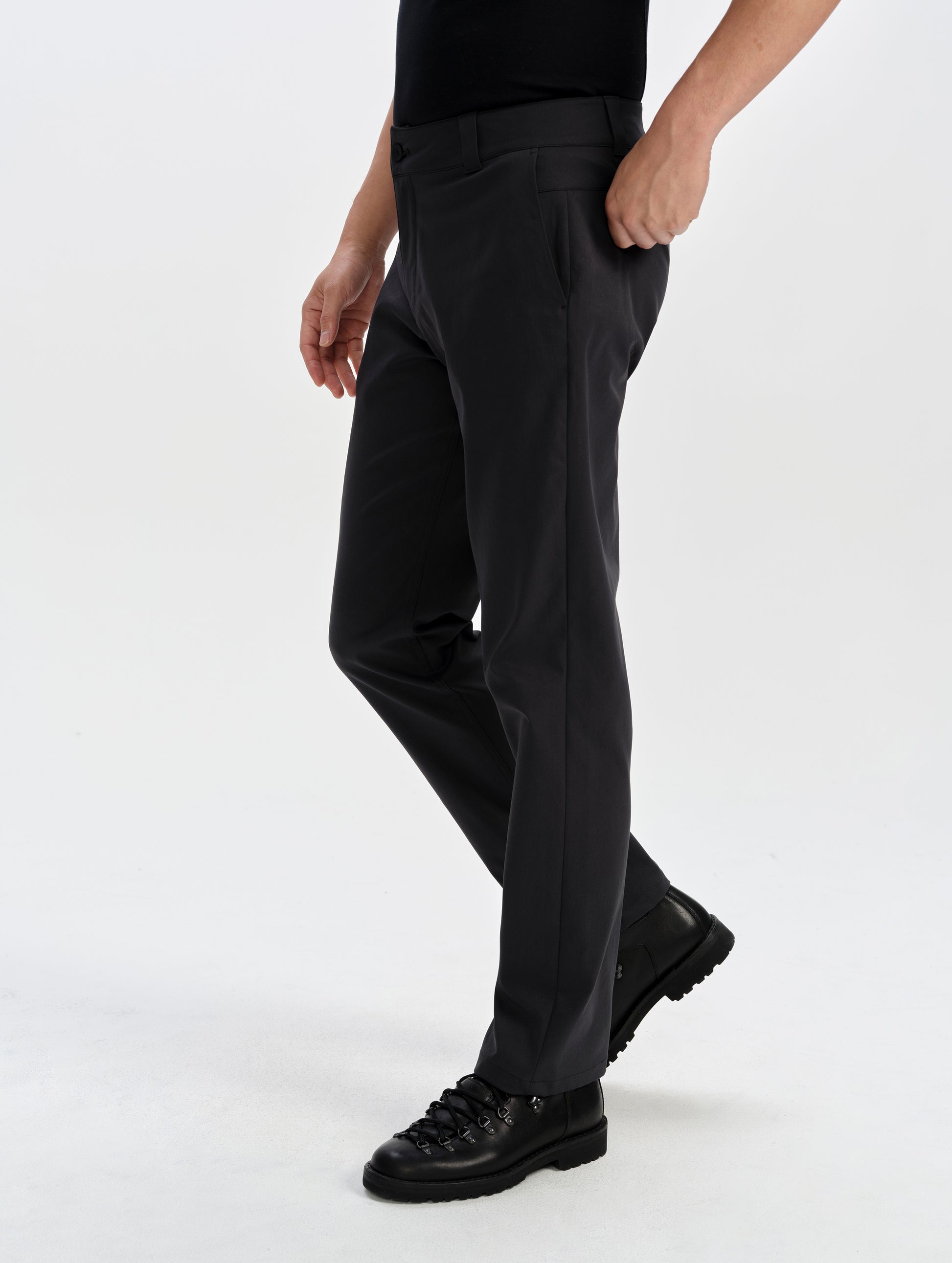 Side profile lower-body view of man wearing the Walden Tech Pant in Onyx Black from AETHER Apparel. 