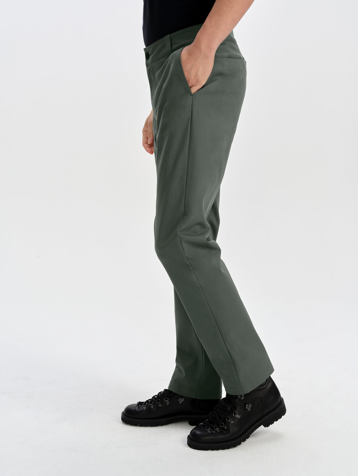 Side profile lower-body view of man wearing the Walden Tech Pant in Saville Green from AETHER Apparel. 
