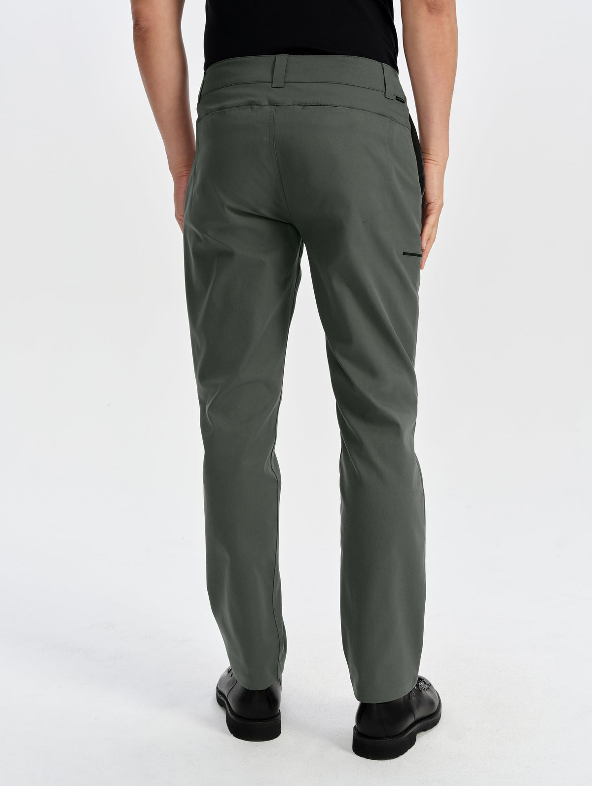 Rear lower-body view of man wearing the Walden Tech Pant in Saville Green from AETHER Apparel. 