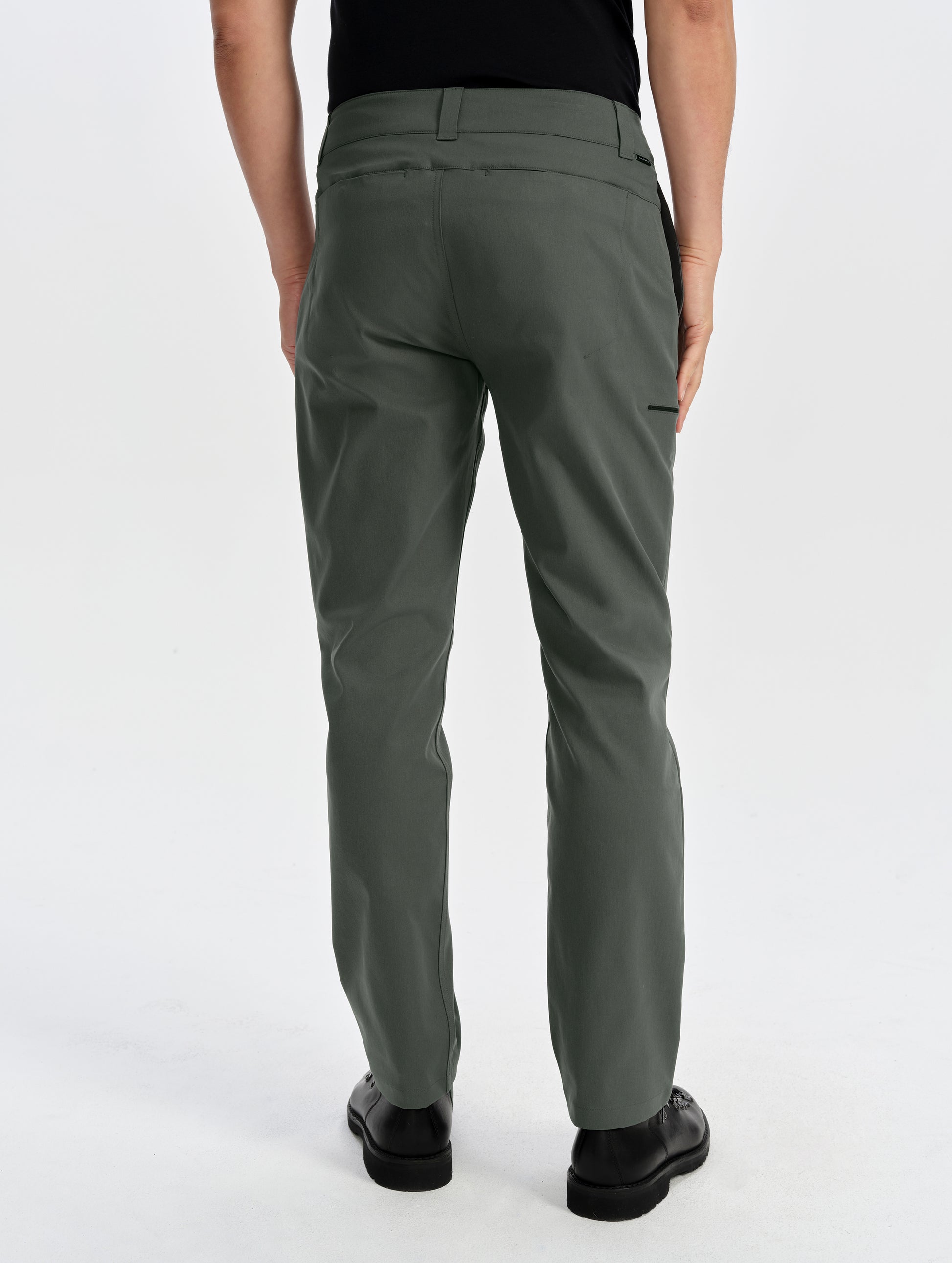 Rear lower-body view of man wearing the Walden Tech Pant in Saville Green from AETHER Apparel. 