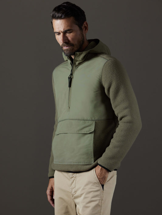 Front 3/4 body view of man wearing Walsh Hooded Anorak in Fern Green from AETHER Apparel.