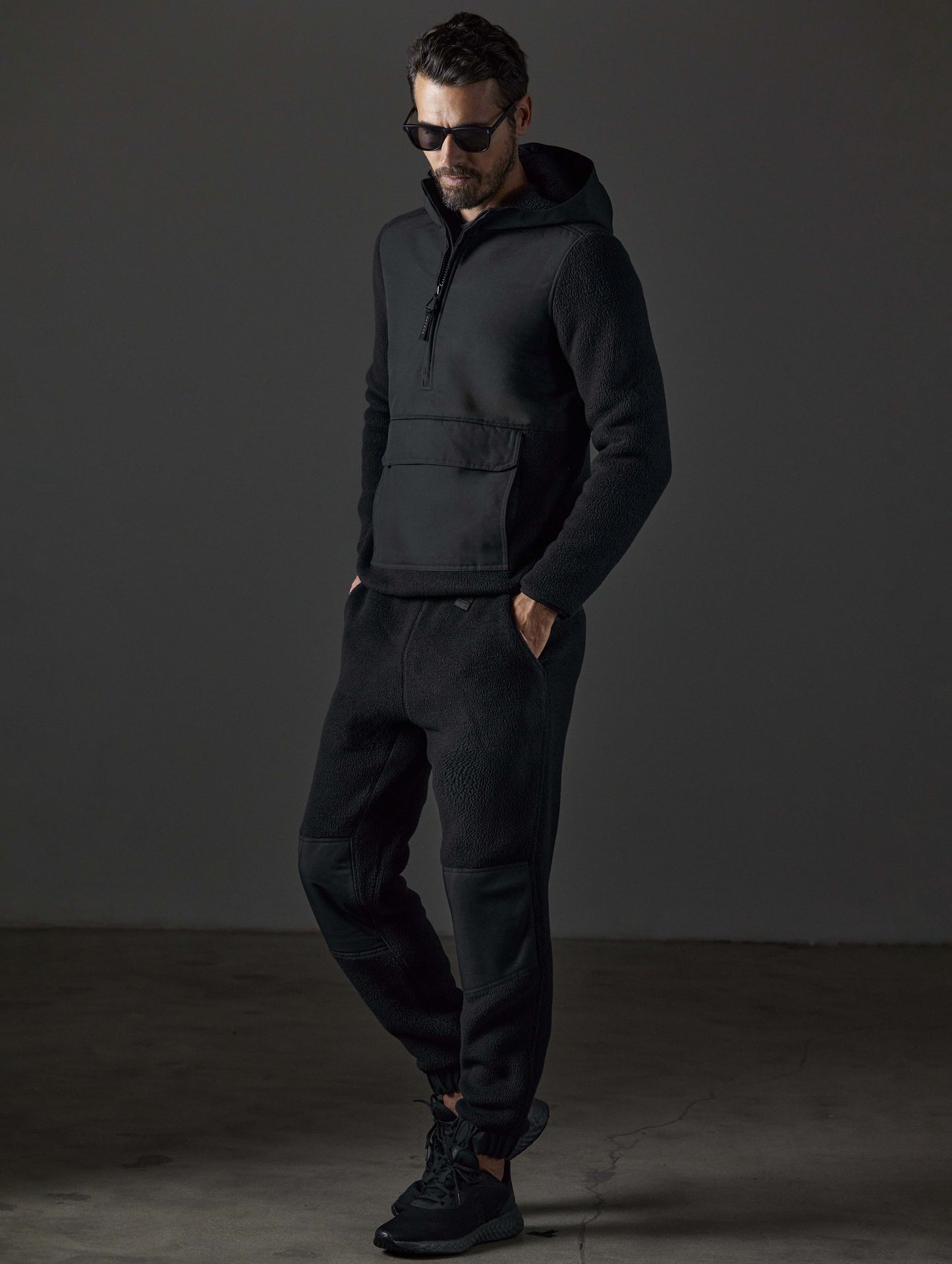 Front 3/4 full-body view of man wearing Walsh Pant in Onyx Black from AETHER Apparel.