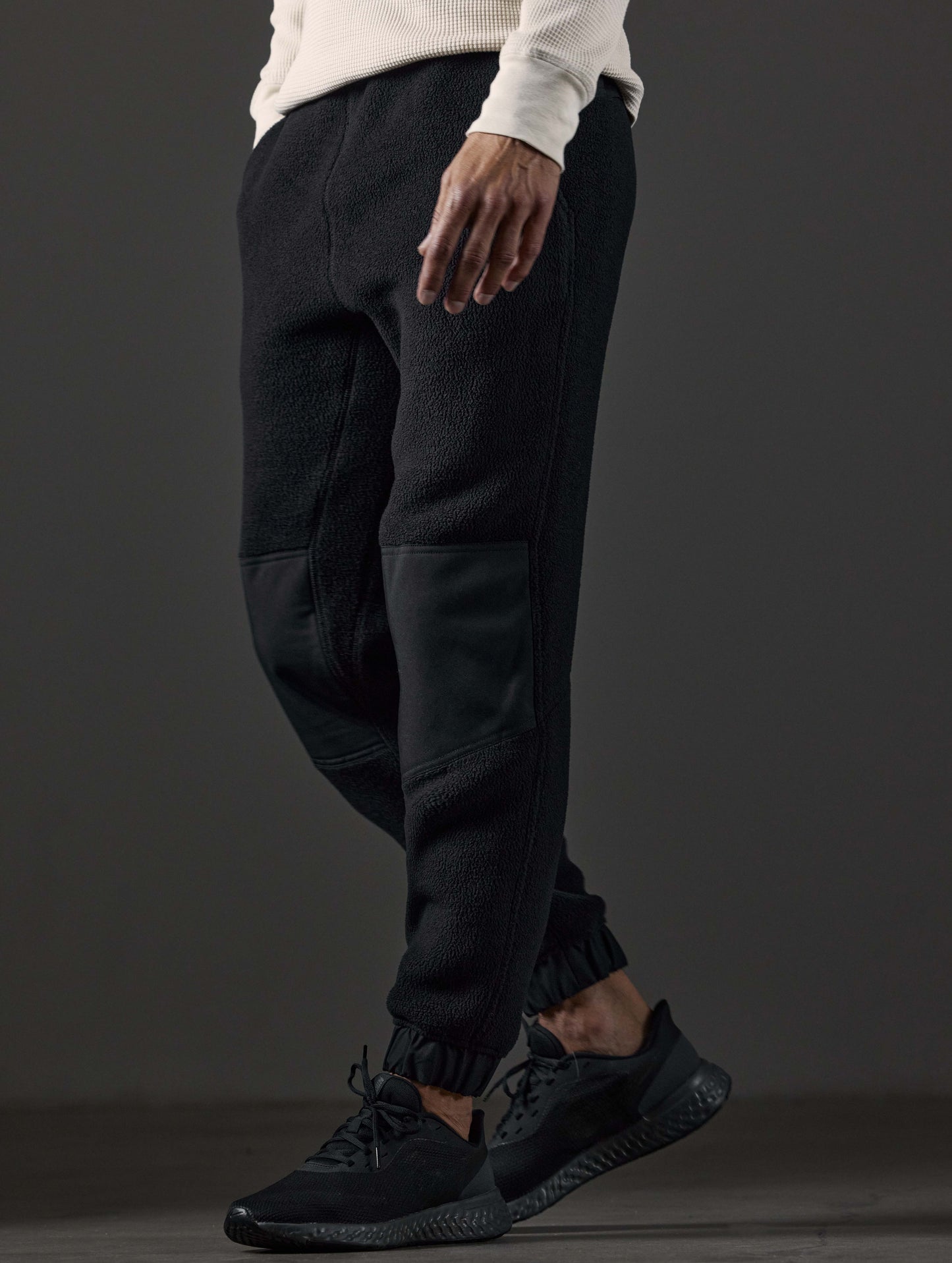 Front 3/4 lower body view of man wearing Walsh Pant in Onyx Black from AETHER Apparel.