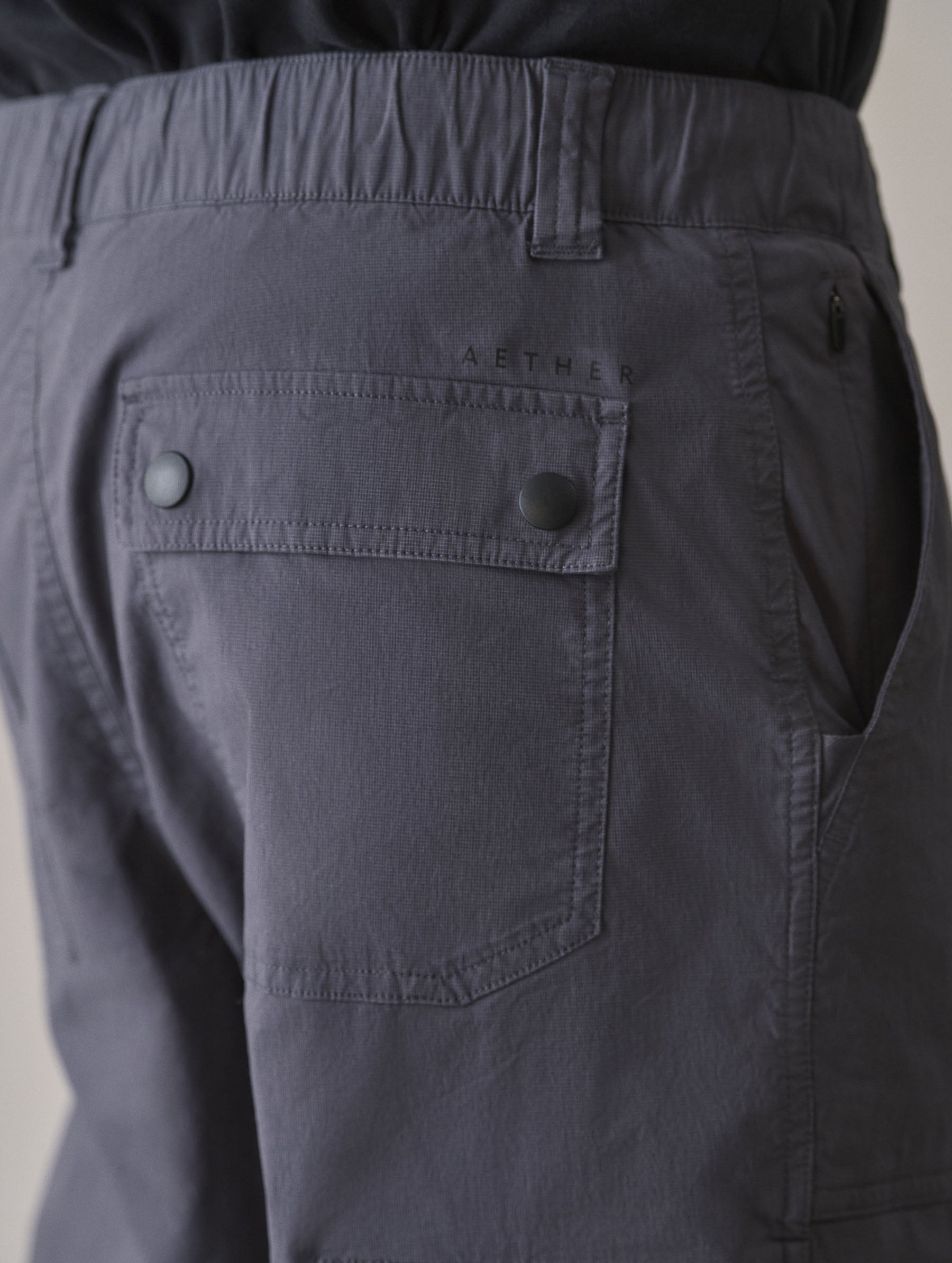 Closeup detailed view of the back patch pockets with flap-snap closures on the Zermatt Hiking Pant in Graphite from AETHER Apparel.