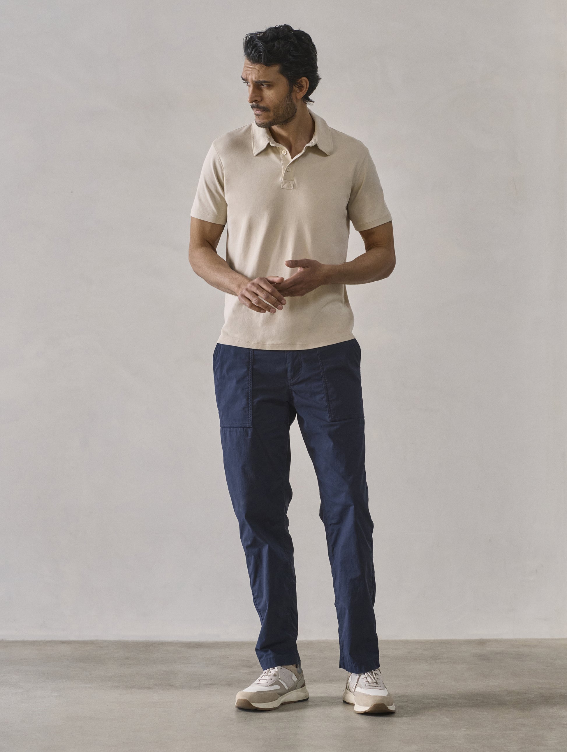 Front full-body view of man wearing Zermatt Hiking Pant in Total Eclipse dark blue from AETHER Apparel.