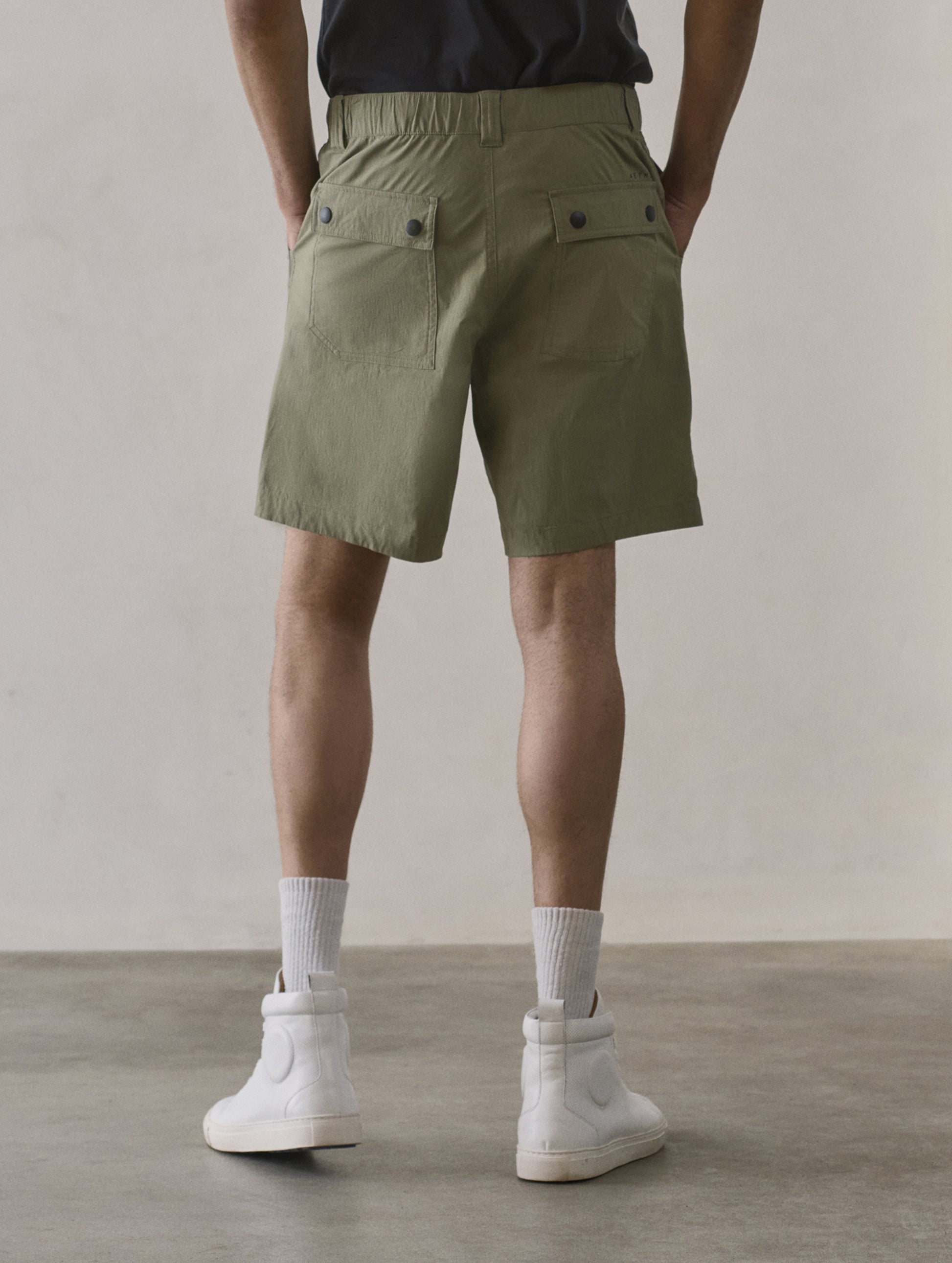 Rear lower body view of man wearing Zermatt Hiking Short in Fern Green from AETHER Apparel.