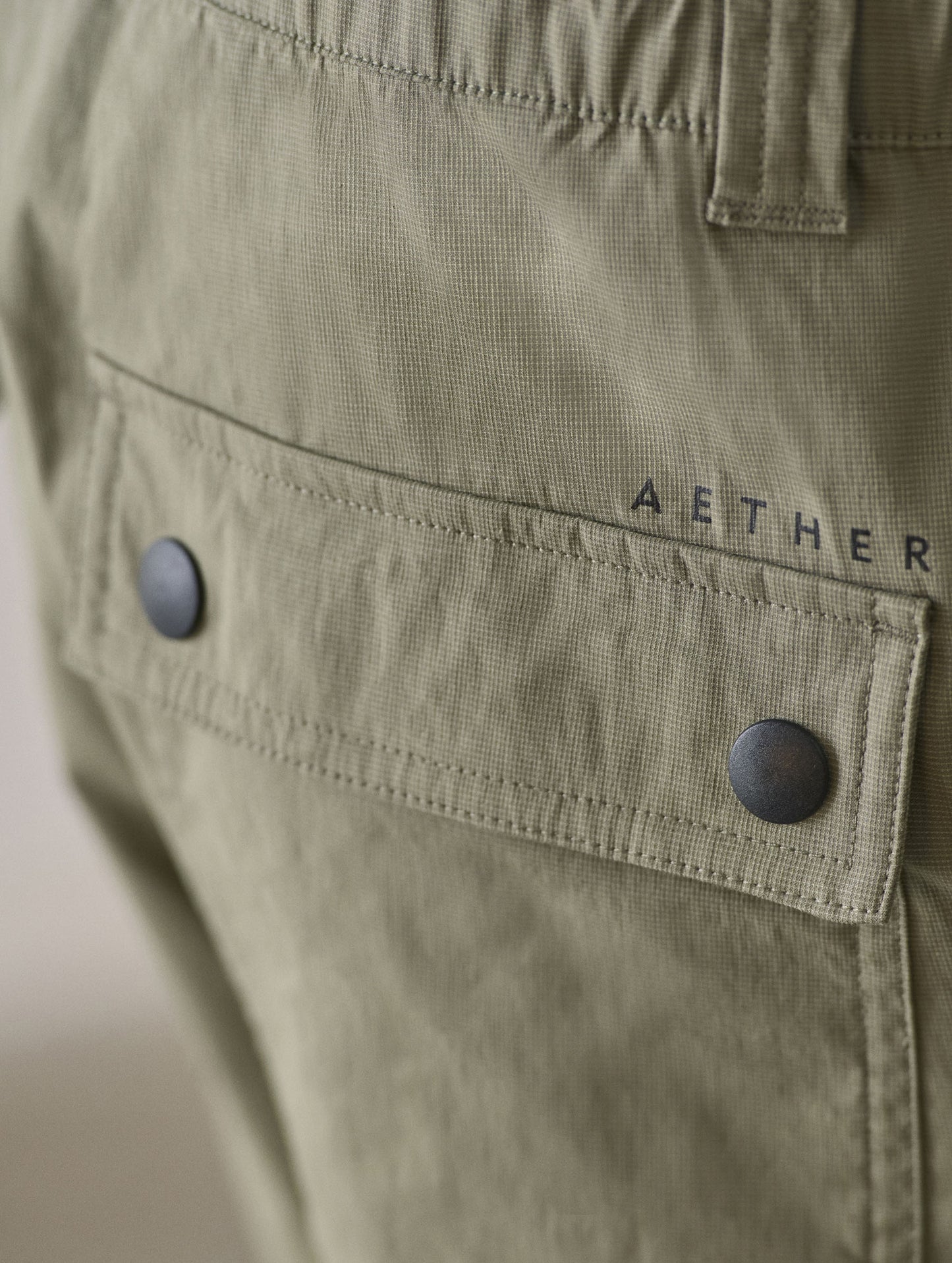 Closeup detailed view of the back patch pockets with flap-snap closures on the Zermatt Hiking Short in Fern Green from AETHER Apparel.