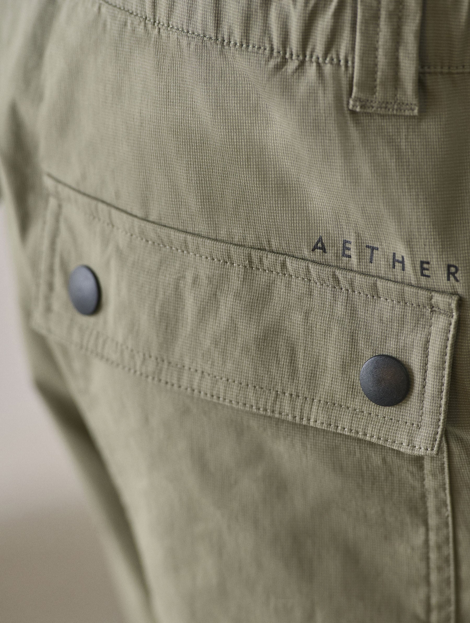 Closeup detailed view of the back patch pockets with flap-snap closures on the Zermatt Hiking Short in Fern Green from AETHER Apparel.