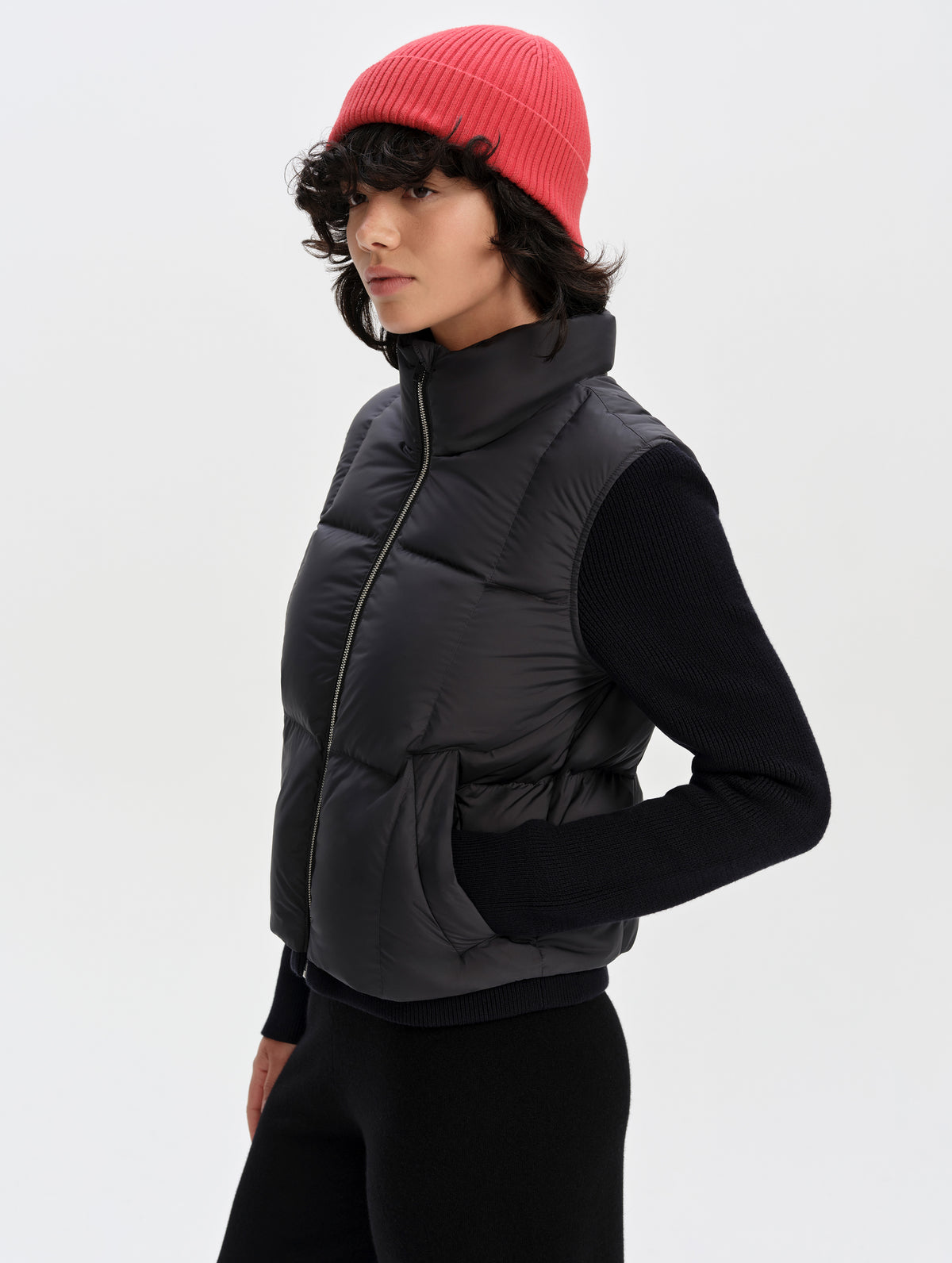 Front 3/4 upper-body view of woman wearing the Nina Sweater Jacket 2.0 in Onyx Black from AETHER Apparel.