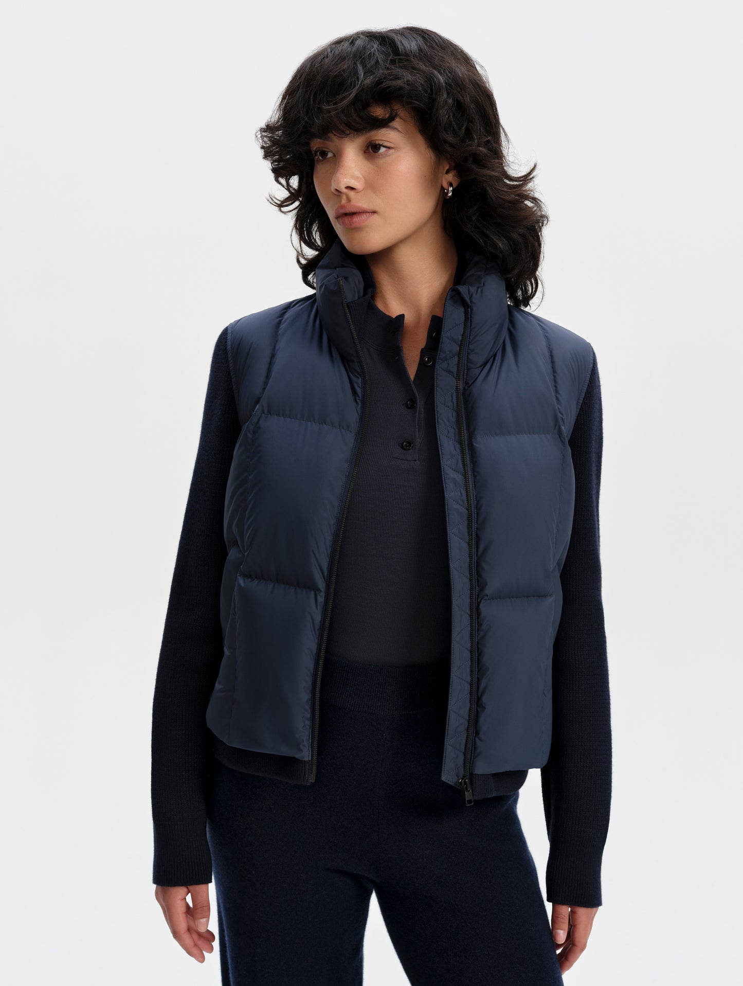 Front upper-body view of woman wearing the Nina Sweater Jacket 2.0 in Total Eclipse from AETHER Apparel.