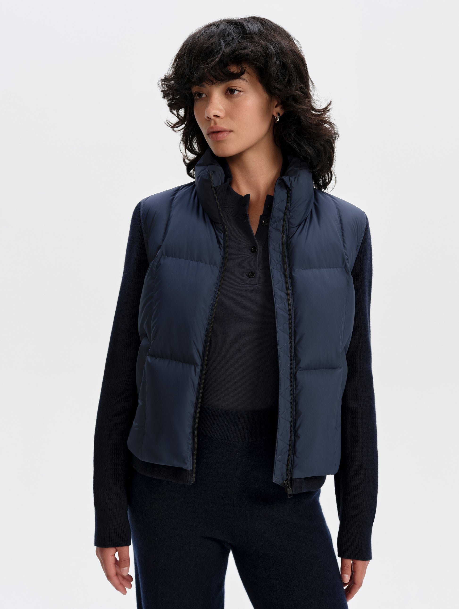 Front upper-body view of woman wearing the Nina Sweater Jacket 2.0 in Total Eclipse from AETHER Apparel.