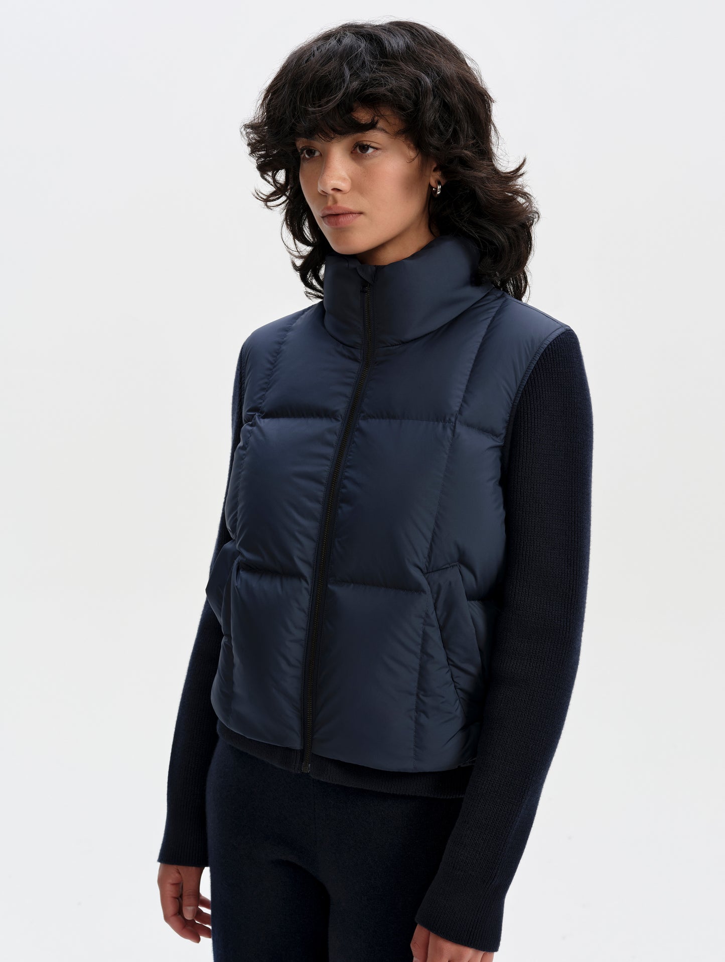 Front 3/4 upper-body view of woman wearing the Nina Sweater Jacket 2.0 in Total Eclipse from AETHER Apparel.