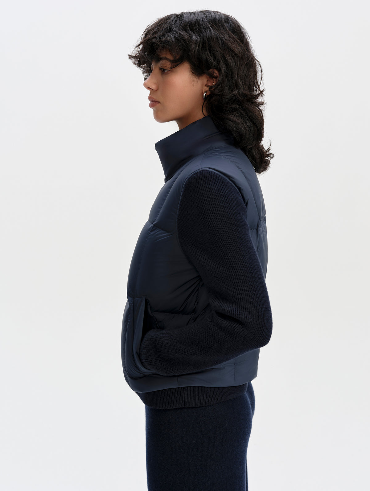 Side profile upper-body view of woman wearing the Nina Sweater Jacket 2.0 in Total Eclipse from AETHER Apparel.
