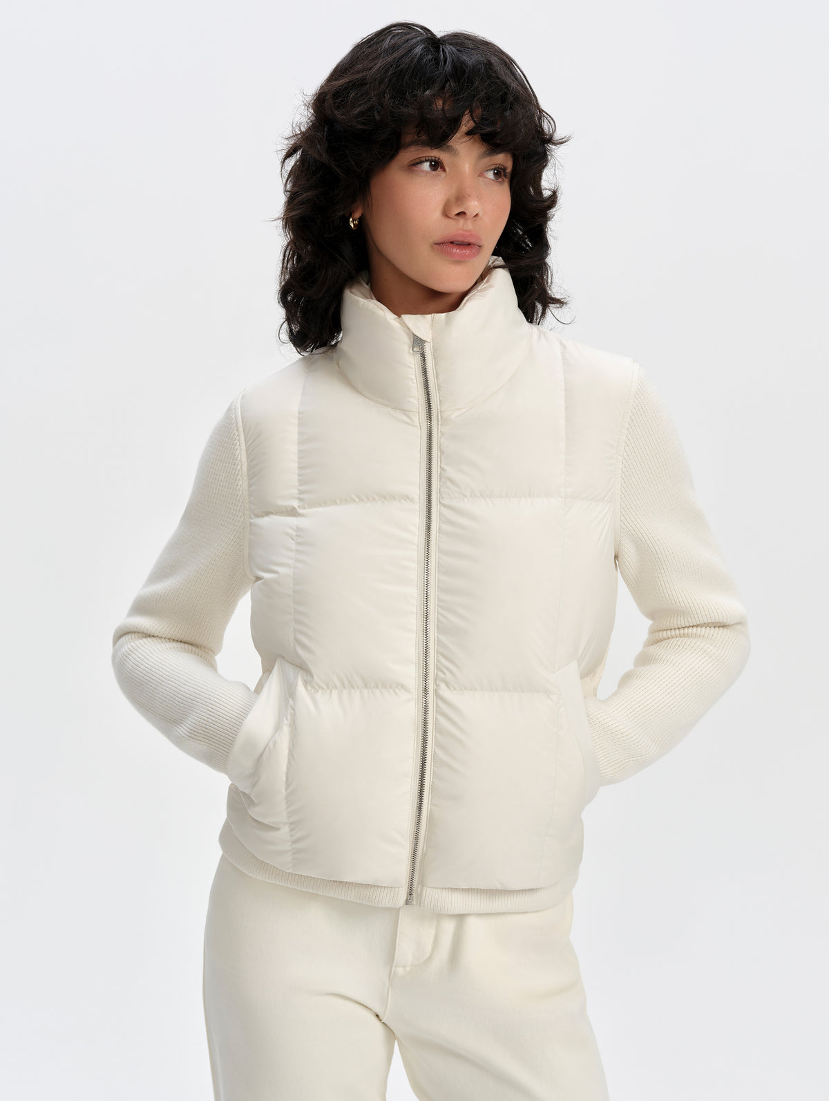 Front upper-body view of woman wearing the Nina Sweater Jacket 2.0 in Winter White from AETHER Apparel.