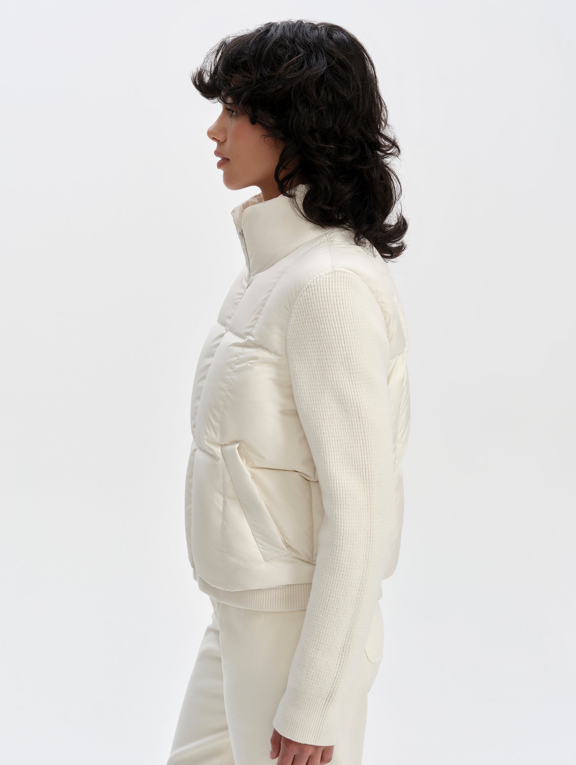 Side profile upper-body view of woman wearing the Nina Sweater Jacket 2.0 in Winter White from AETHER Apparel.