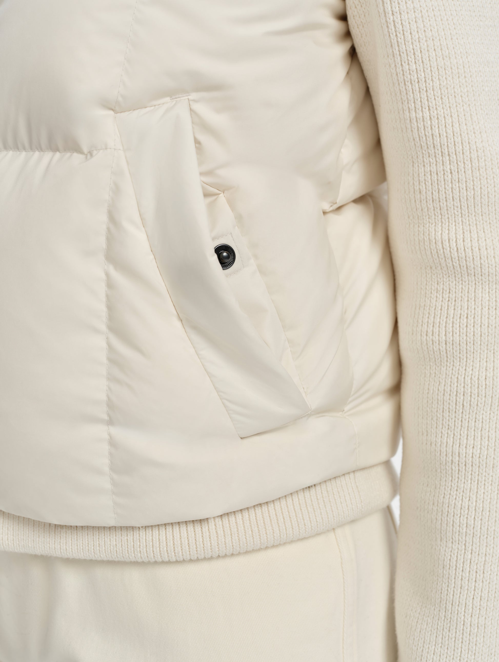 Closeup detailed view of the snap-secured pocket on the Nina Sweater Jacket 2.0 in Winter White from AETHER Apparel.