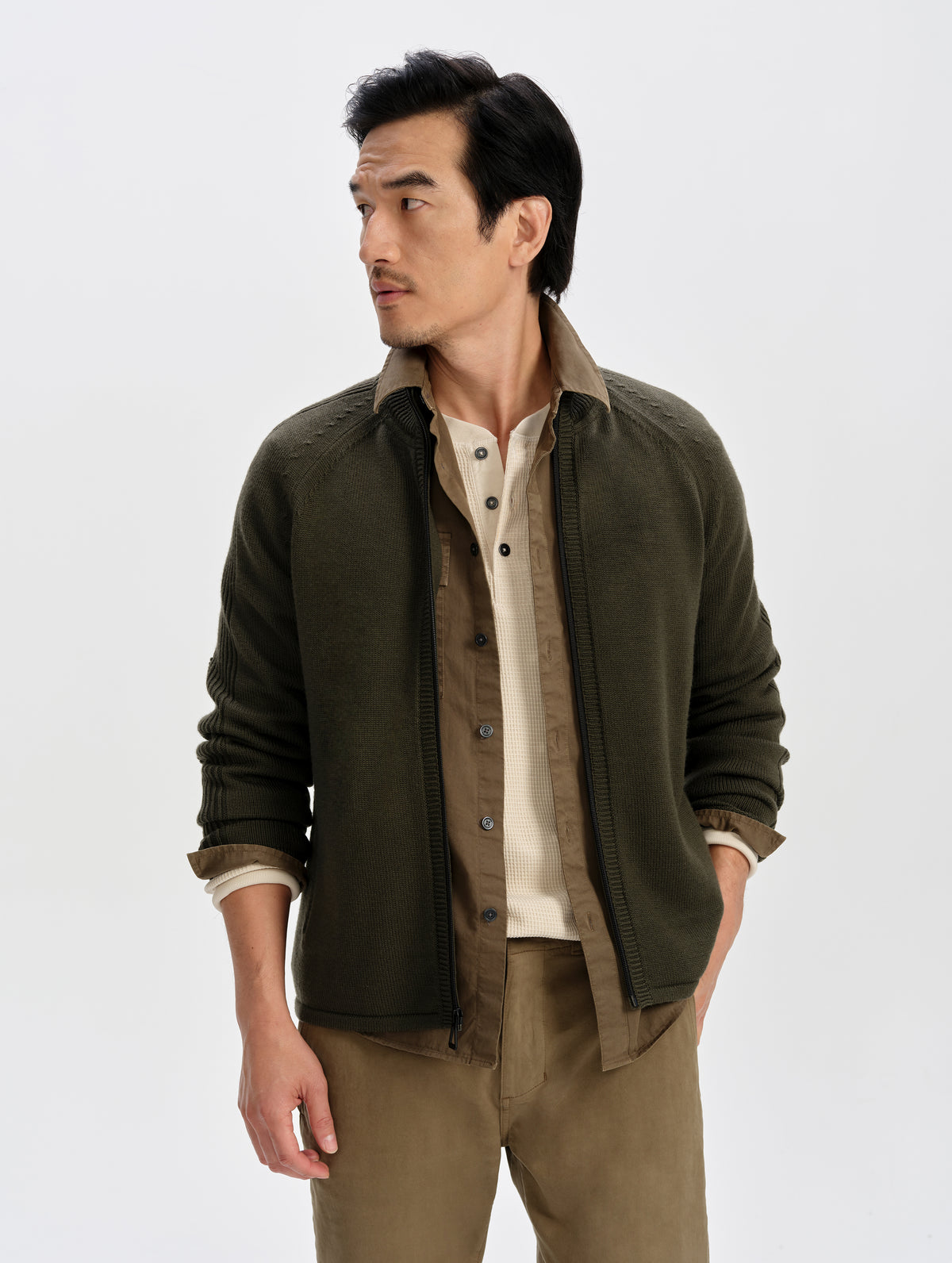 Front upper-body view of man wearing the Riley Full-Zip Sweater in Forest Green from AETHER Apparel. 