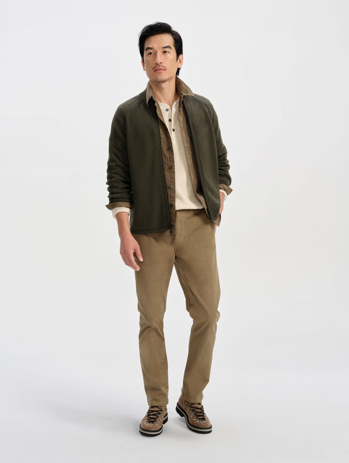 Front full-body view of man wearing the Riley Full-Zip Sweater in Forest Green from AETHER Apparel. 