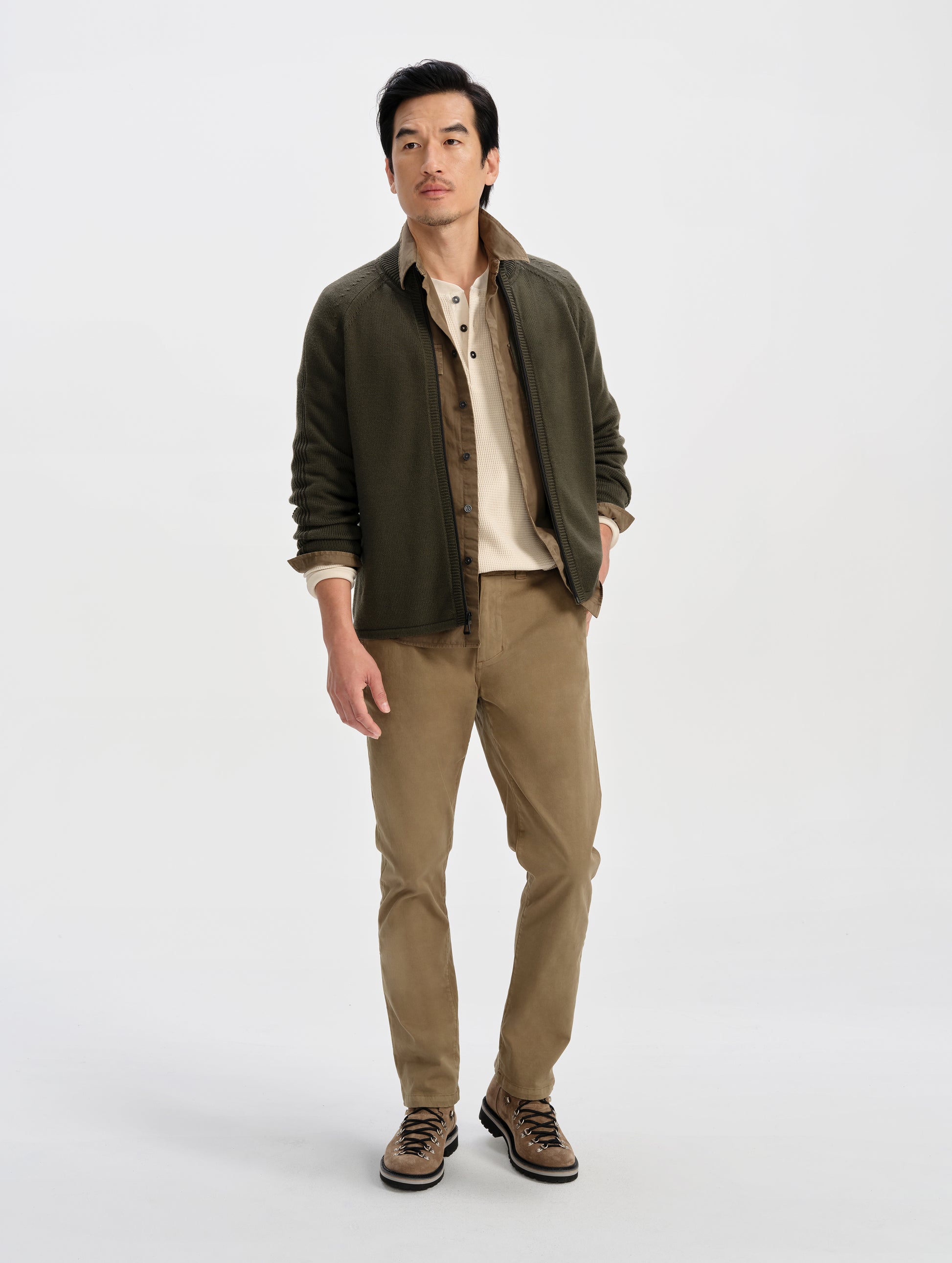 Front full-body view of man wearing the Riley Full-Zip Sweater in Forest Green from AETHER Apparel. 