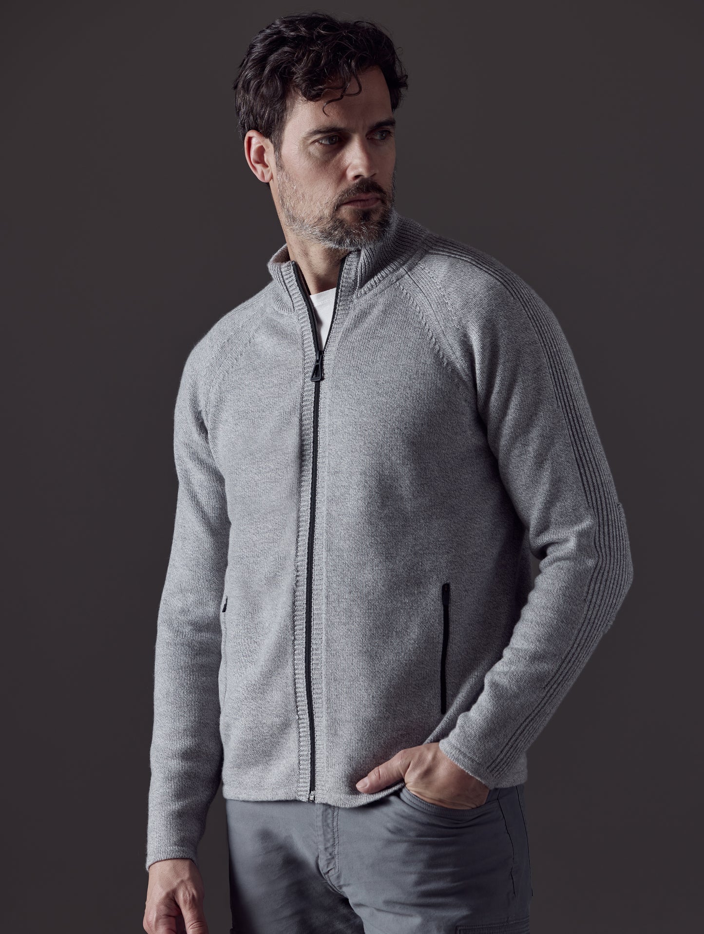 Man wearing grey Riley Full-Zip Sweater from AETHER Apparel