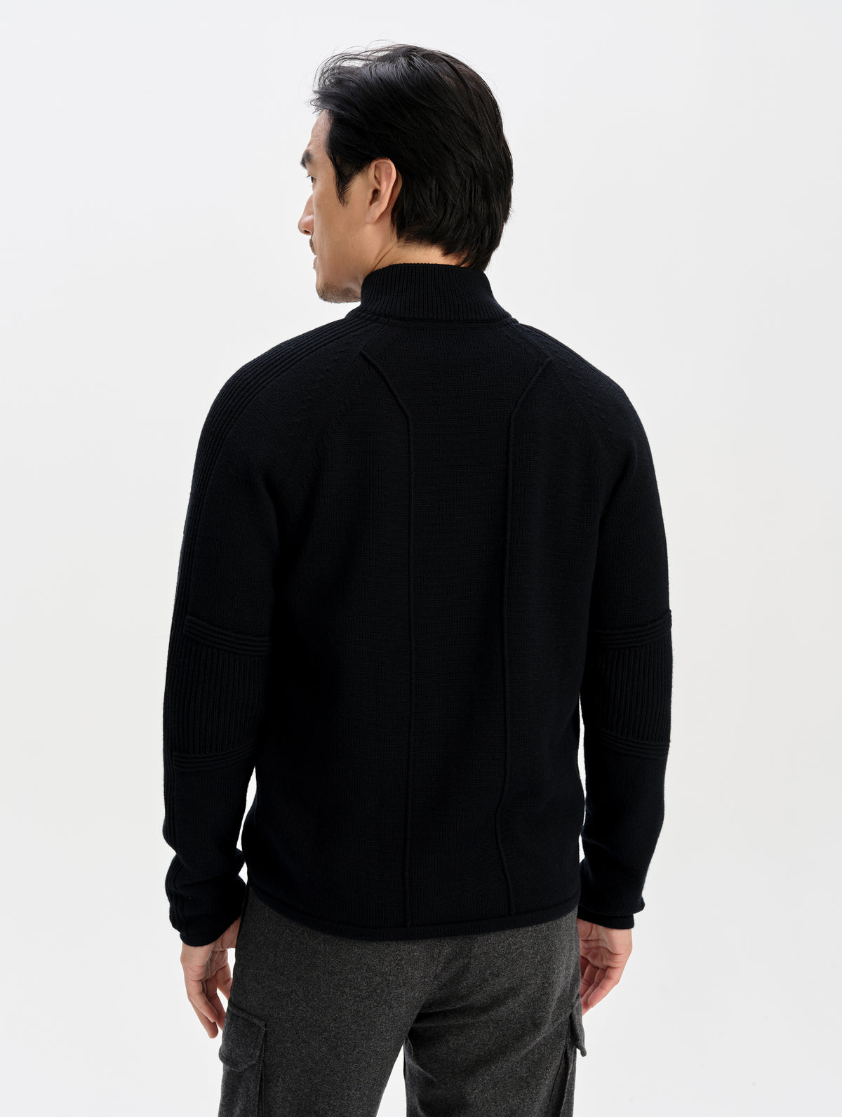 Rear upper-body view of man wearing the Riley Full-Zip Sweater in Onyx Black from AETHER Apparel. 