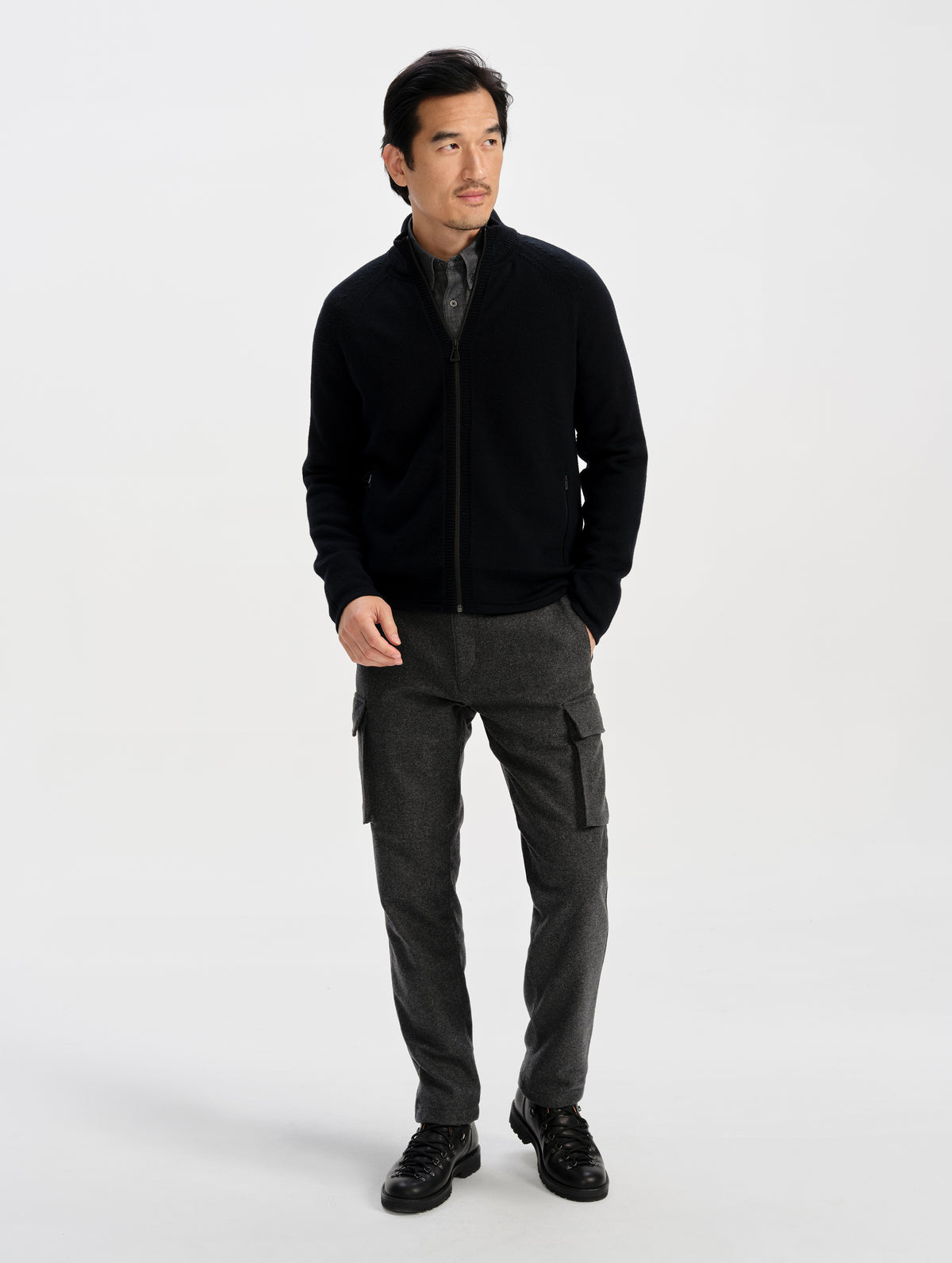 Front full-body view of man wearing the Riley Full-Zip Sweater in Onyx Black from AETHER Apparel. 