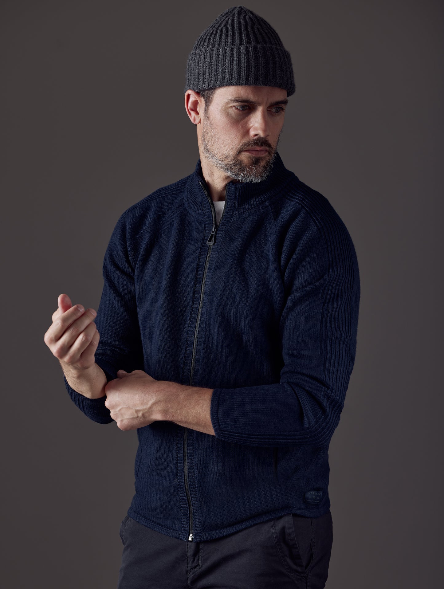 Man wearing dark blue Riley Full-Zip Sweater