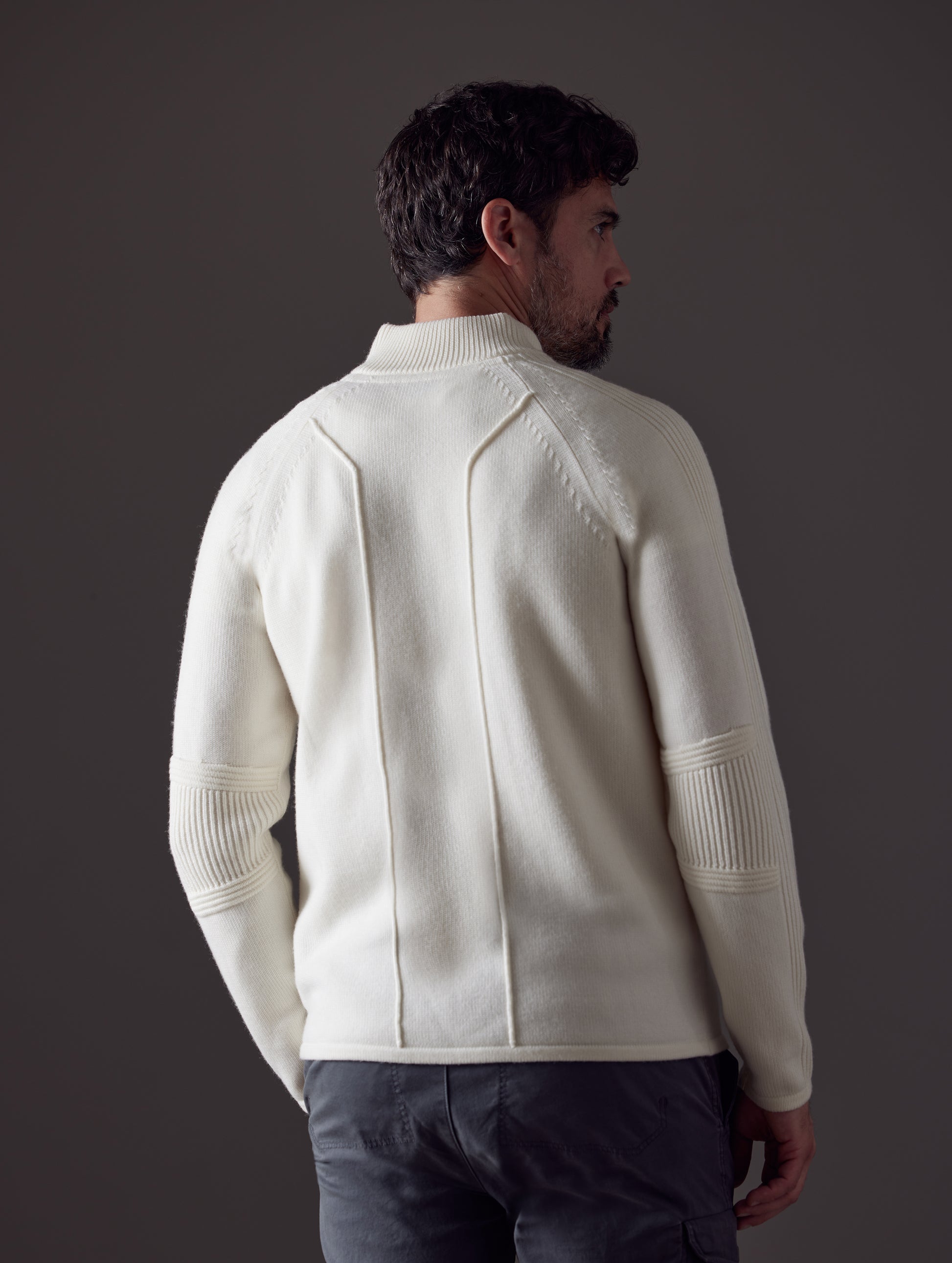 Man wearing white Riley Full-Zip Sweater from AETHER Apparel