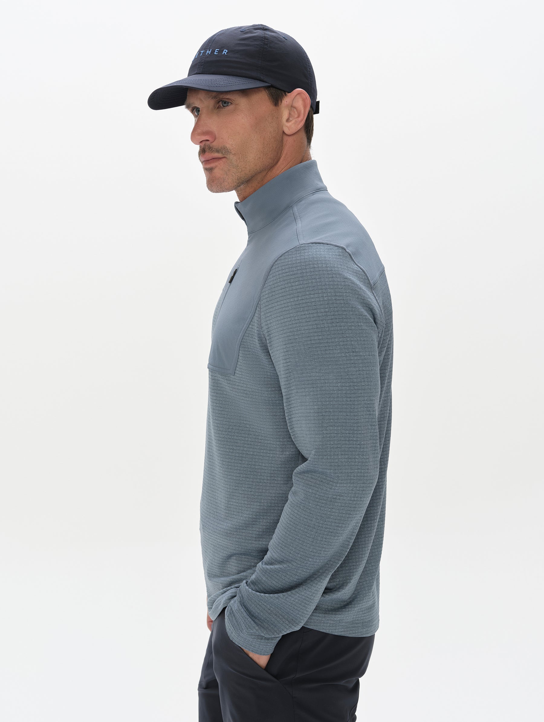 Side profile view of man wearing the Rocklin Half-Zip in Portal Blue from AETHER Apparel.