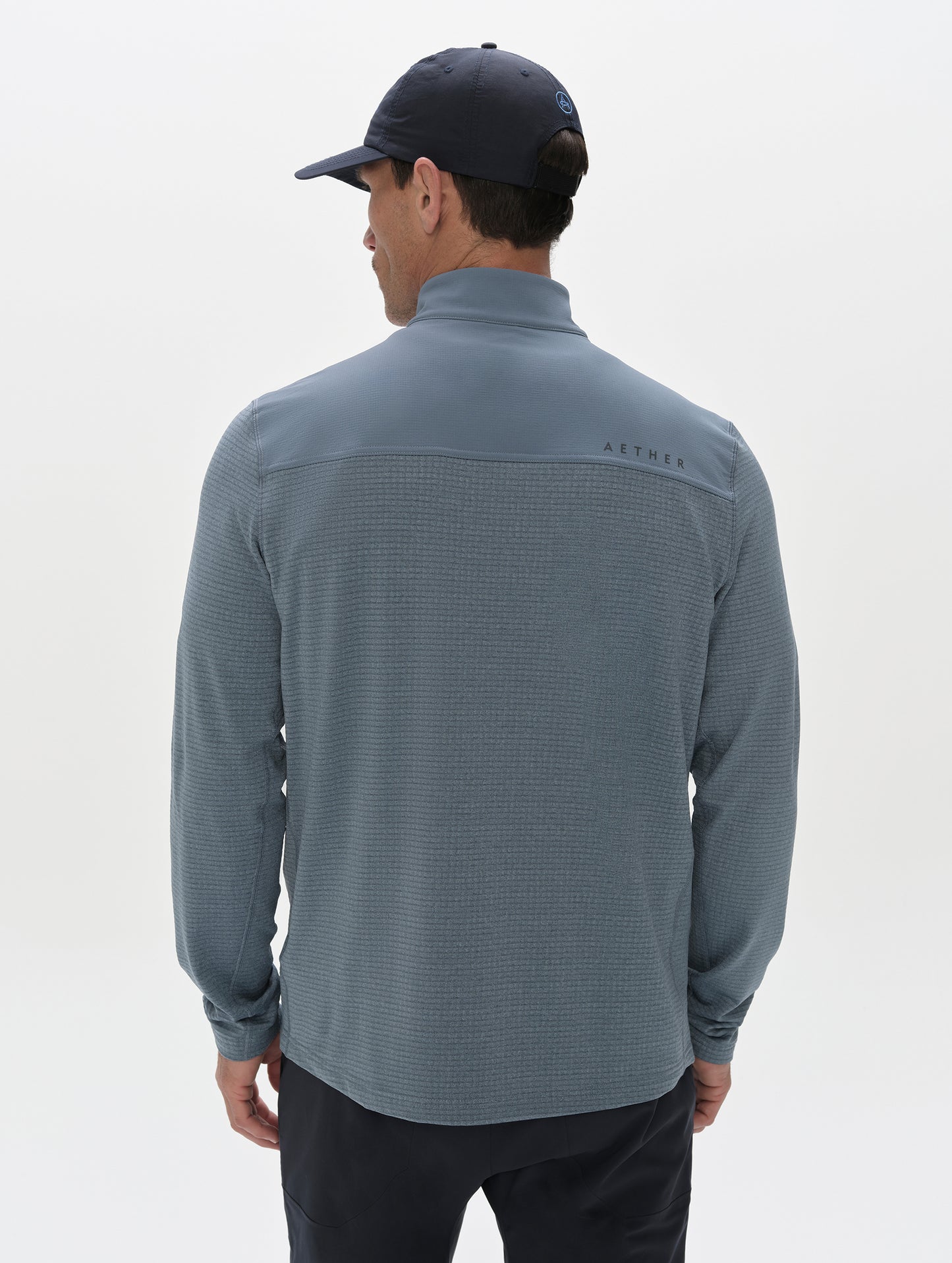 Rear view of man wearing the Rocklin Half-Zip in Portal Blue from AETHER Apparel.