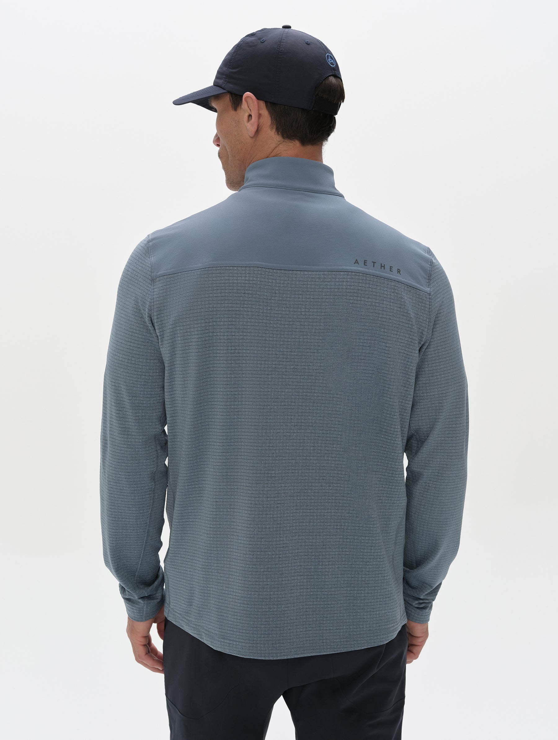 Rear view of man wearing the Rocklin Half-Zip in Portal Blue from AETHER Apparel.