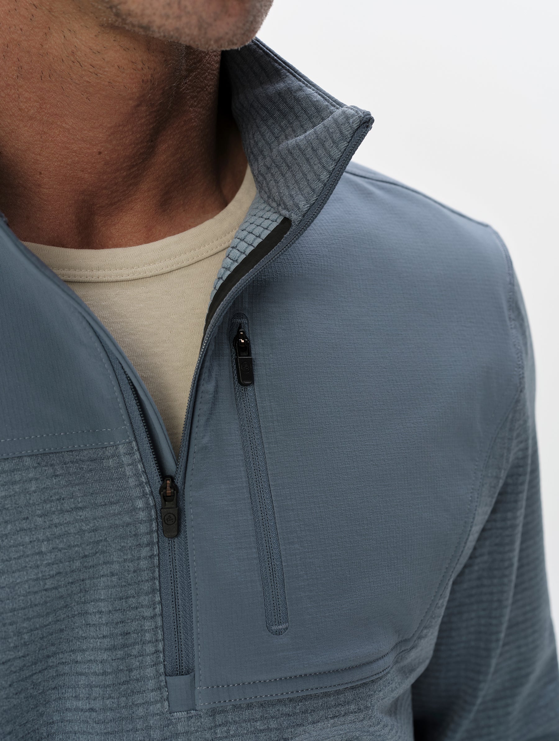 Closeup detailed view of the half-zipper on the Rocklin Half-Zip in Portal Blue from AETHER Apparel.