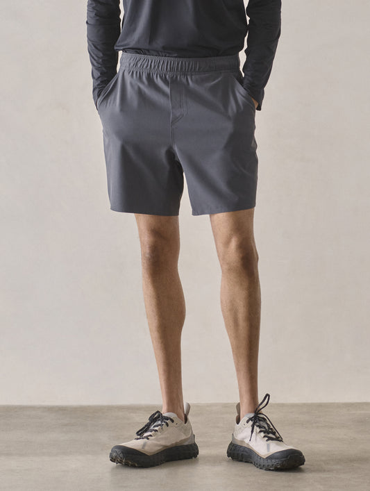 Front lower-body view of man wearing Rogue Hybrid Short in Graphite from AETHER Apparel.