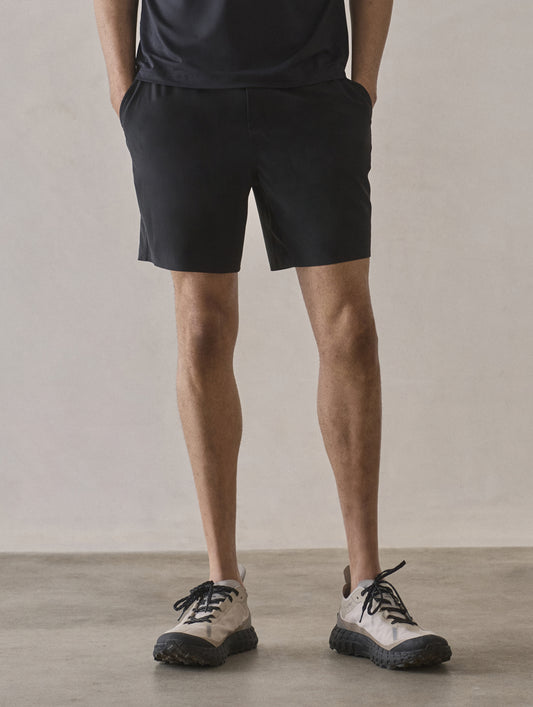 Front lower-body view of man wearing Rogue Hybrid Short in Onyx Black from AETHER Apparel.
