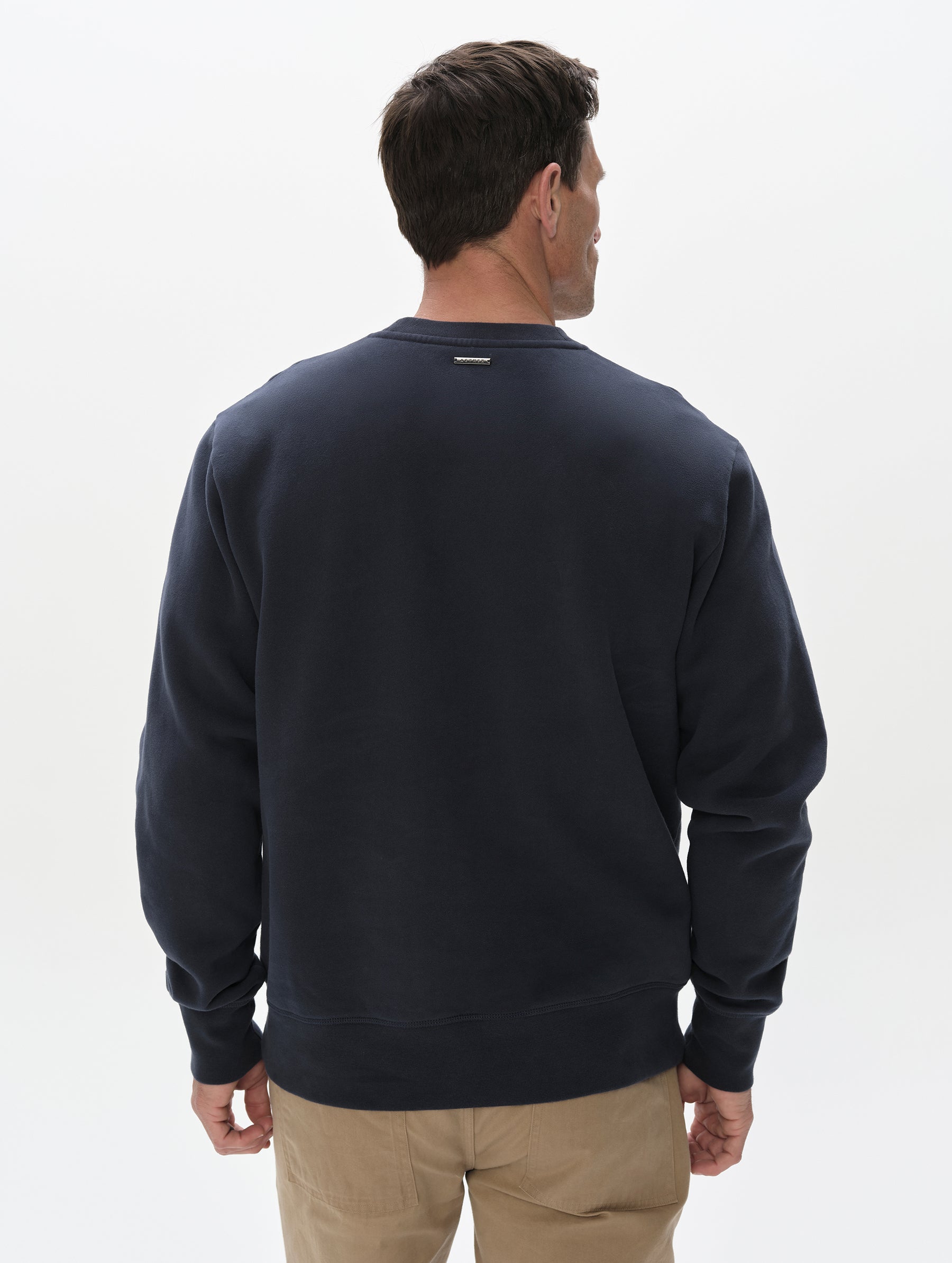 Rear, upper-body view of man wearing the Rylan Crewneck Sweatshirt in Total Eclipse from AETHER Apparel.
