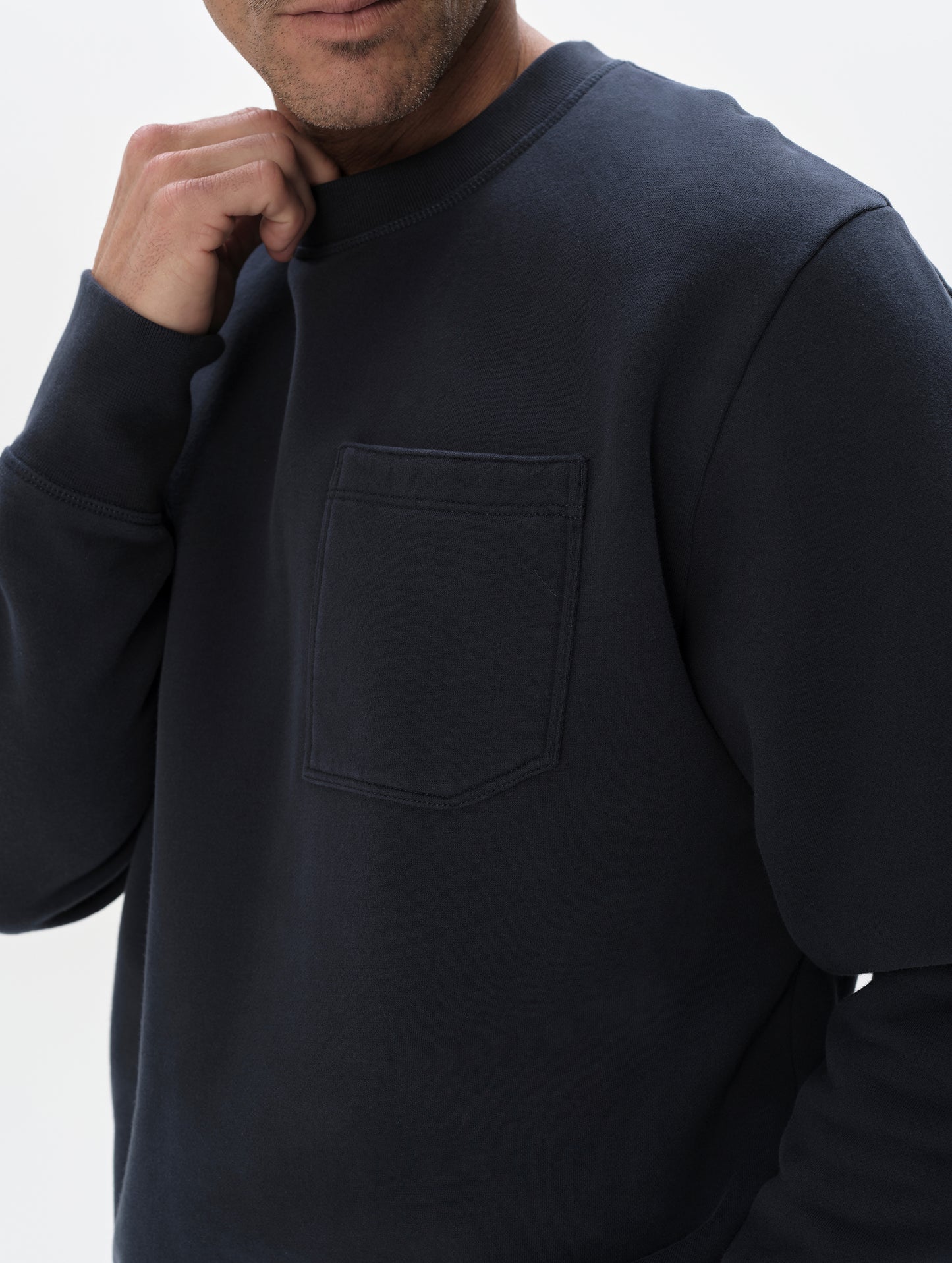 Closeup detailed view of the shoulder and patch pocket on the Rylan Crewneck Sweatshirt in Total Eclipse from AETHER Apparel.
