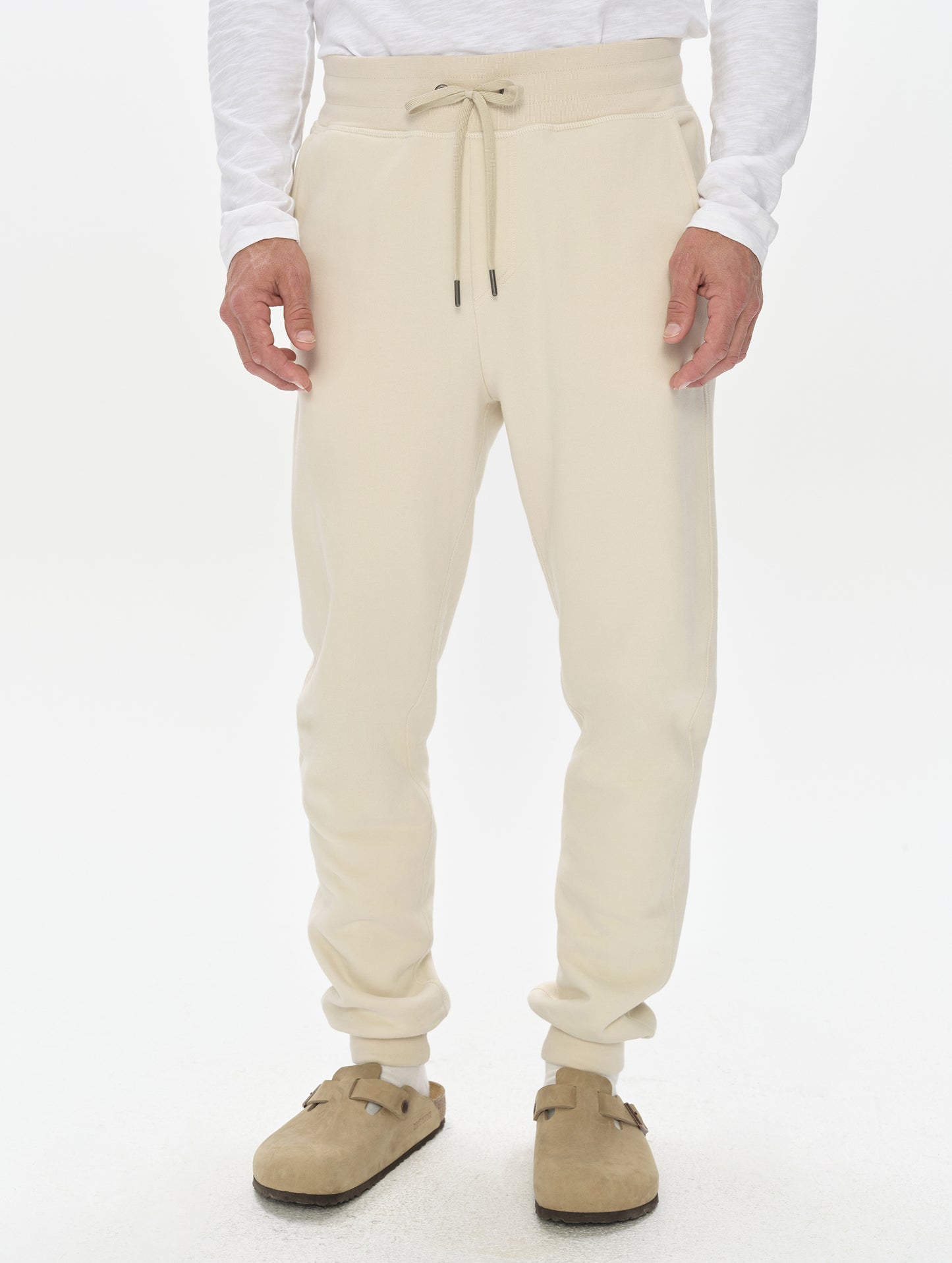 Front, lower-body view of man wearing the Rylan Cuffed Sweatpant in Bone from AETHER Apparel.