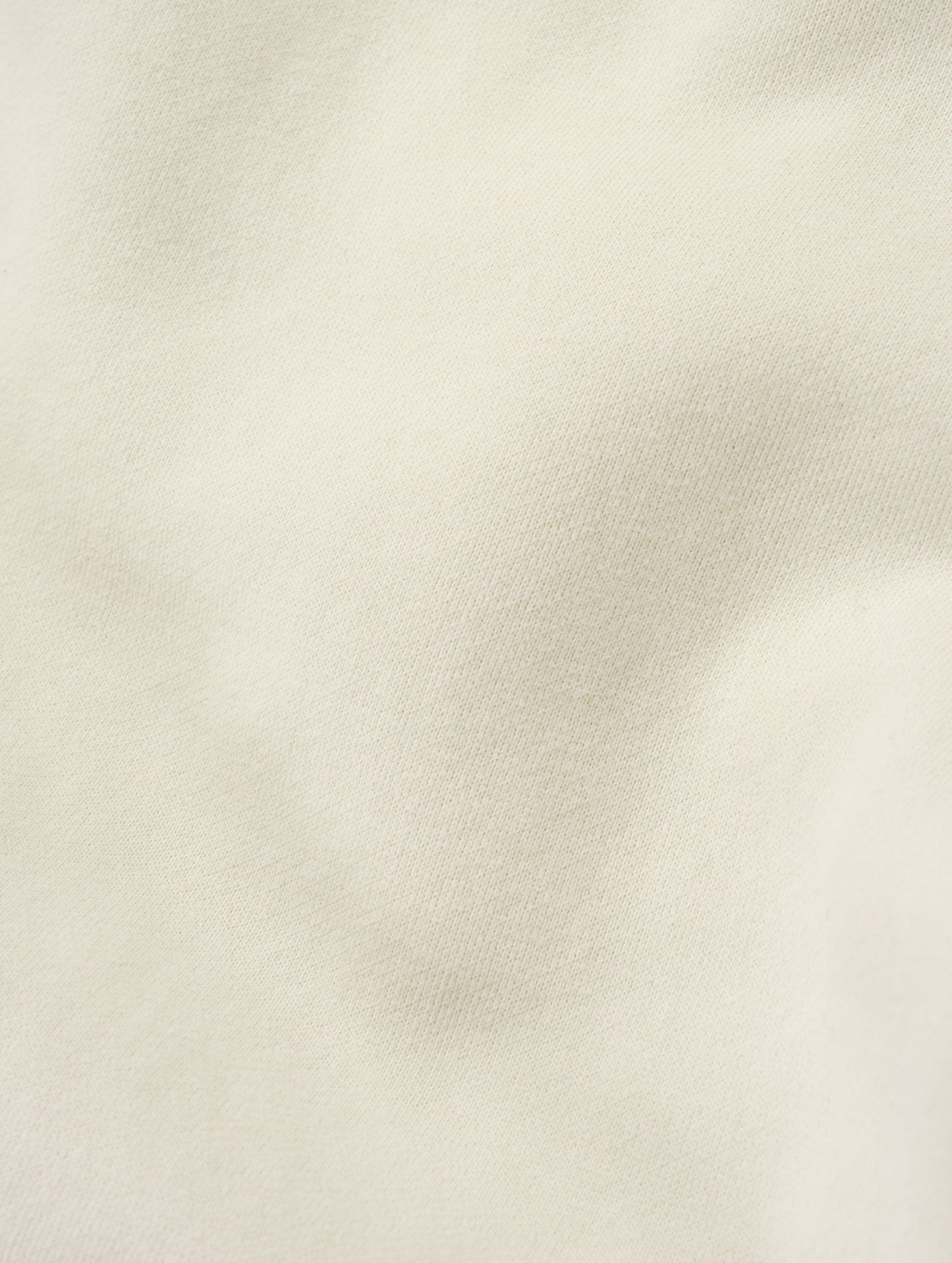 Closeup detailed view of the ultra-soft carbon brushed fleece cotton on the Rylan Sweat Pant in Bone from AETHER Apparel. 